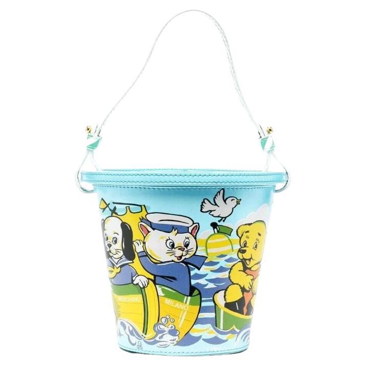 SS22 Moschino Couture Child's Fantasy Sand Bucket Top Handle Bag by Jeremy Scott For Sale