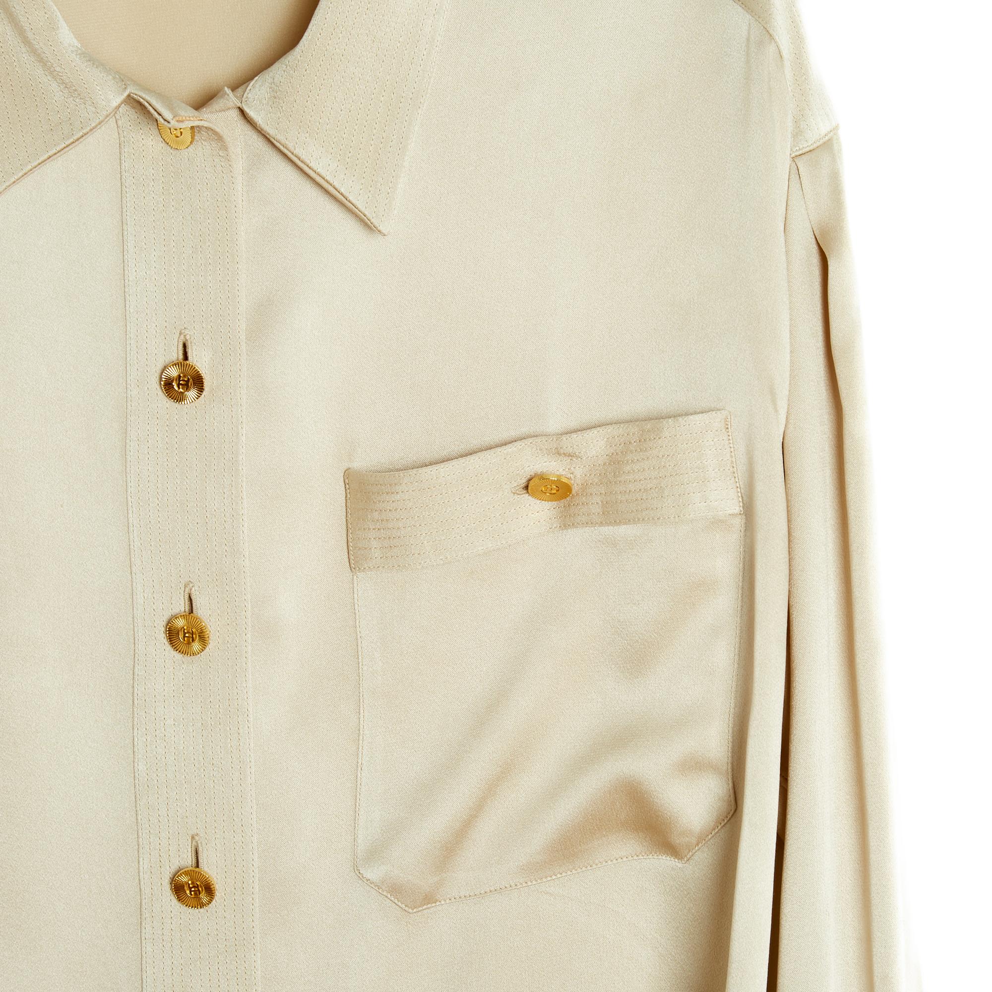 Top Chanel Spring Summer 1995 collection slightly oversized full-length blouse in beige silk satin, collar closed with 7 CC logo buttons in gold metal, patch chest pocket closed with a button, 