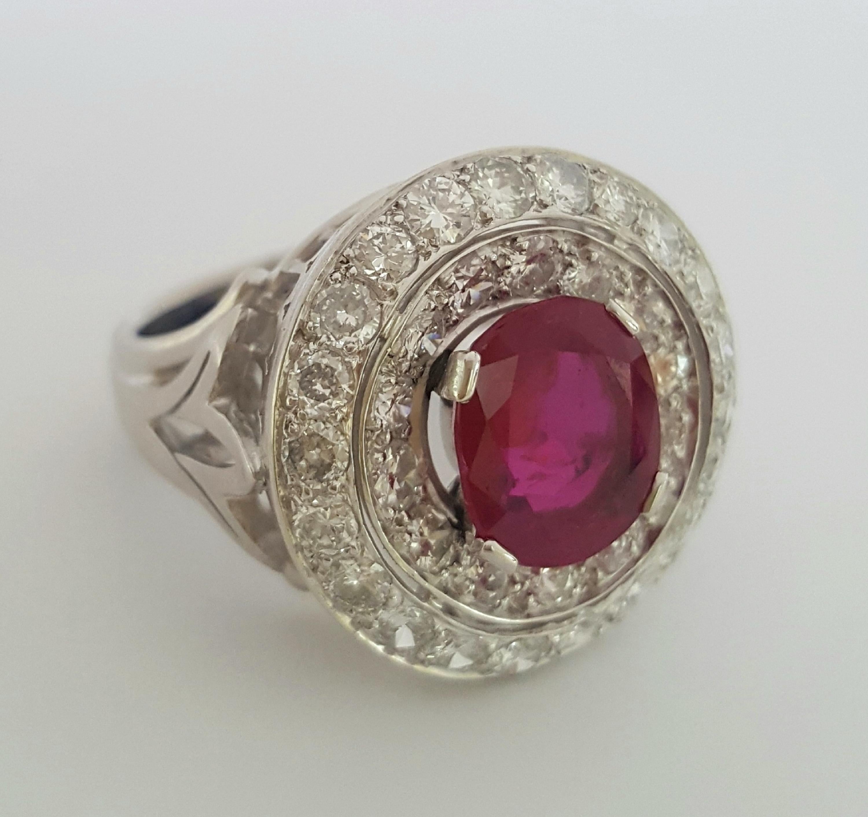 This crisp, elegant and polished ring designed and created by Moguldiam Inc features a SSEF certified oval brilliant purplish red ruby burma no heat encircled with a row of white small round brilliant diamonds and another row of bigger white round
