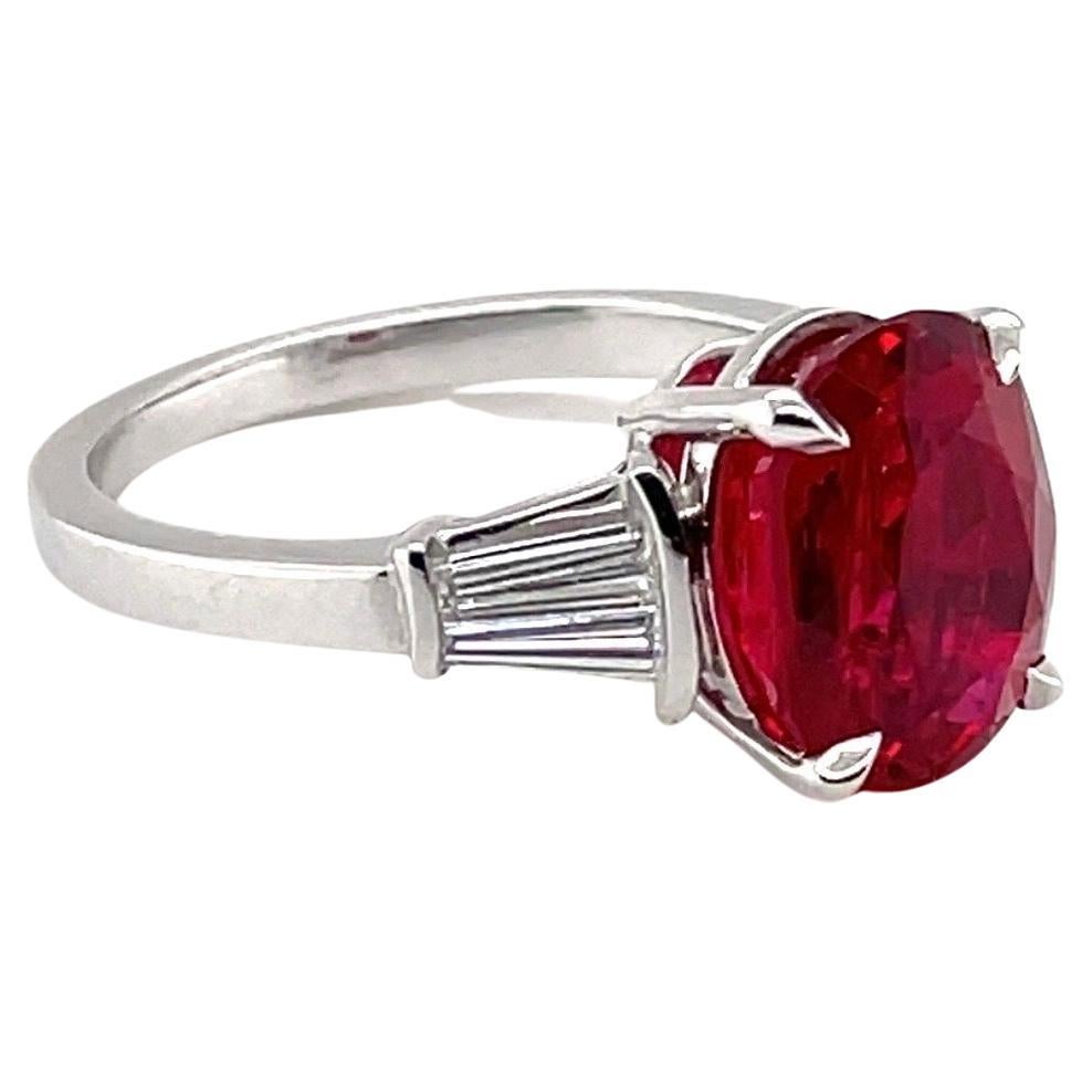 SSEF certified 3.39 carats red, oval, unheated Burma spinel and diamond ring.  

Elegant, eye-catching Solitaire ring crafted in 18 karat white gold and centering upon one red, oval Burma spinel of 3.39 carats, flanked by four tapered baguette-cut