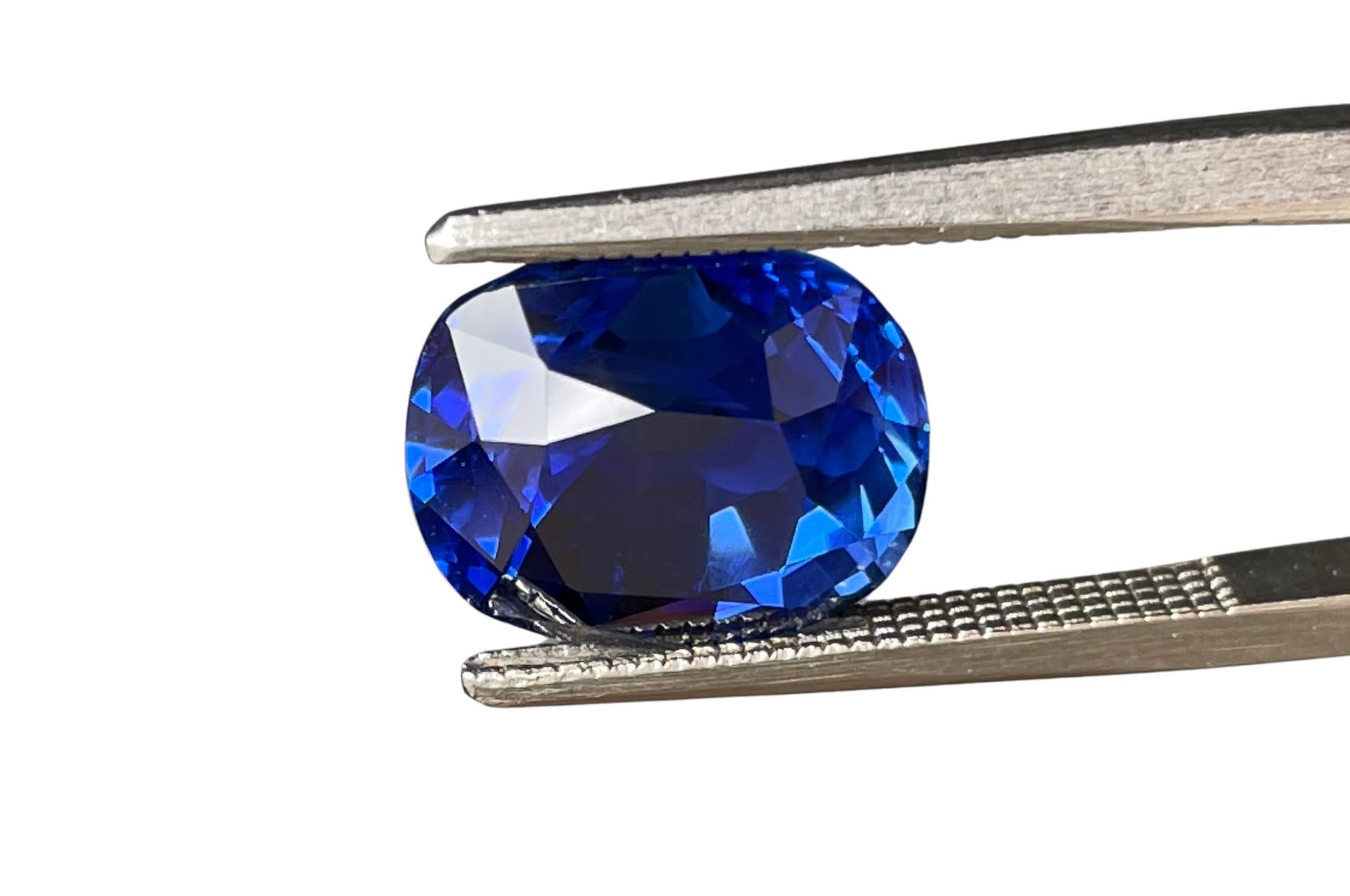 This exquisite ring features an SSEF certified 4.17 carat cushion cut vivid blue no-heat Kashmir sapphire, showcasing unparalleled color and clarity. Flanked by two trapezoid diamonds on either side, the sapphire is set in an elegant 18K white gold