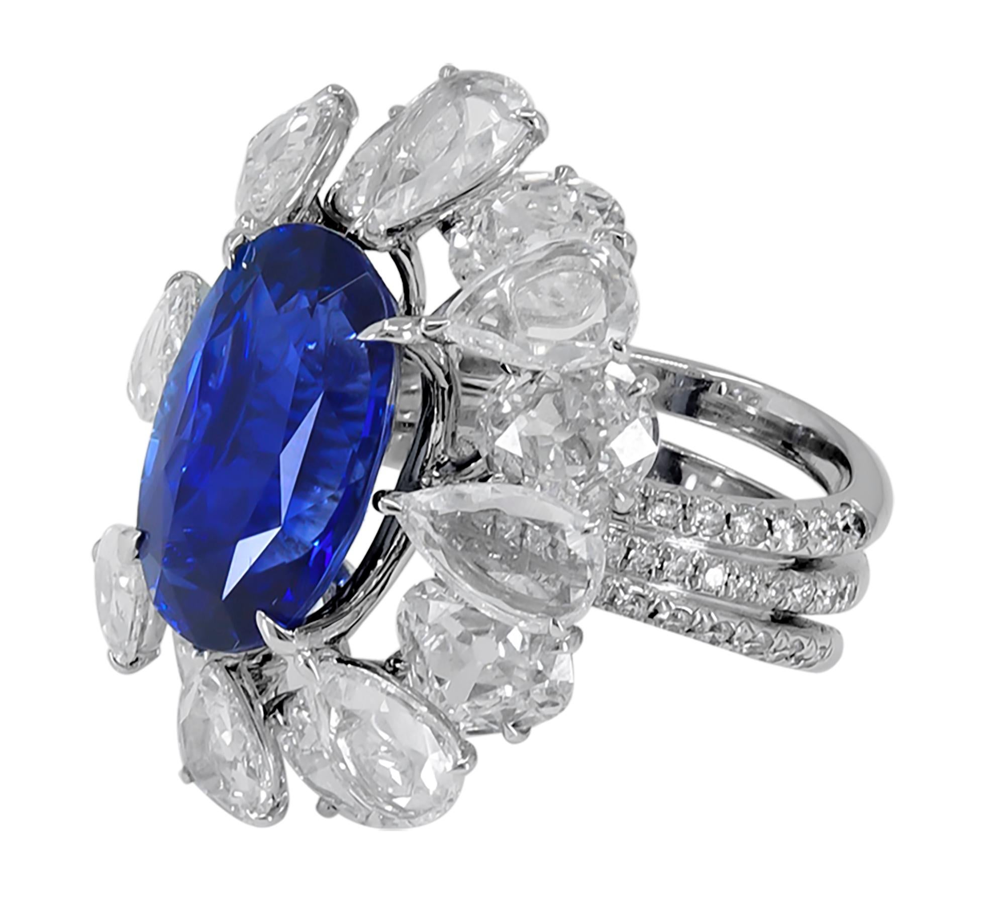 A beautiful ring featuring a 9.01 carat oval step cut blue sapphire with a halo encrusted with round and pear shape rose cut diamonds weighing total 8.43 carats. The ring is accompanied by a SSEF lab report stating that the sapphire is of Ceylon