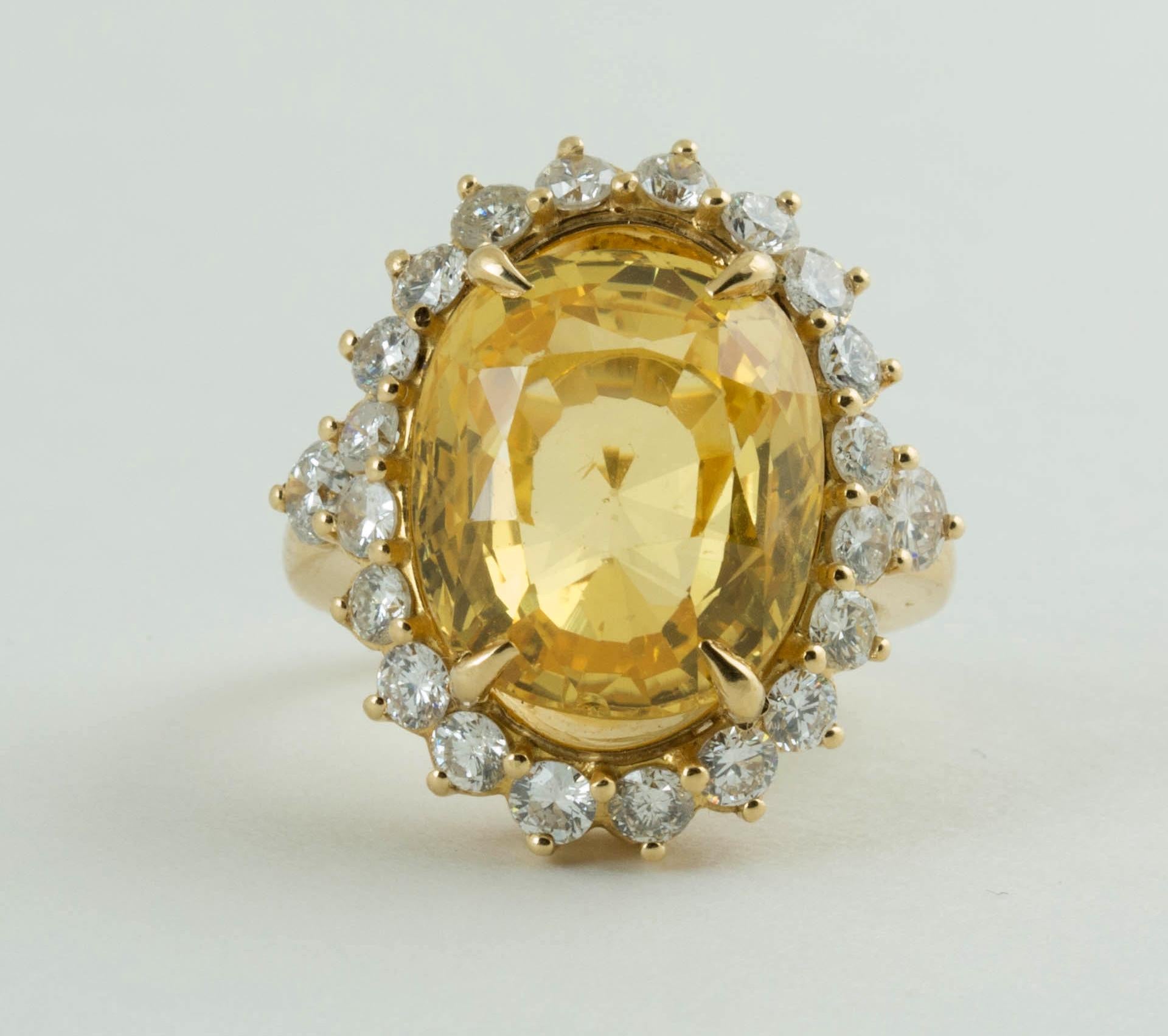 An antique 14 carat cushion mixed cut natural no heat yellow sapphire and diamond ring.
Size of sapphire is 14.5mm x 12.35mm x 8.15mm. it is medium tone, strong saturation, yellow hue. come with Swiss Gemological Institute report #107813. 
There are