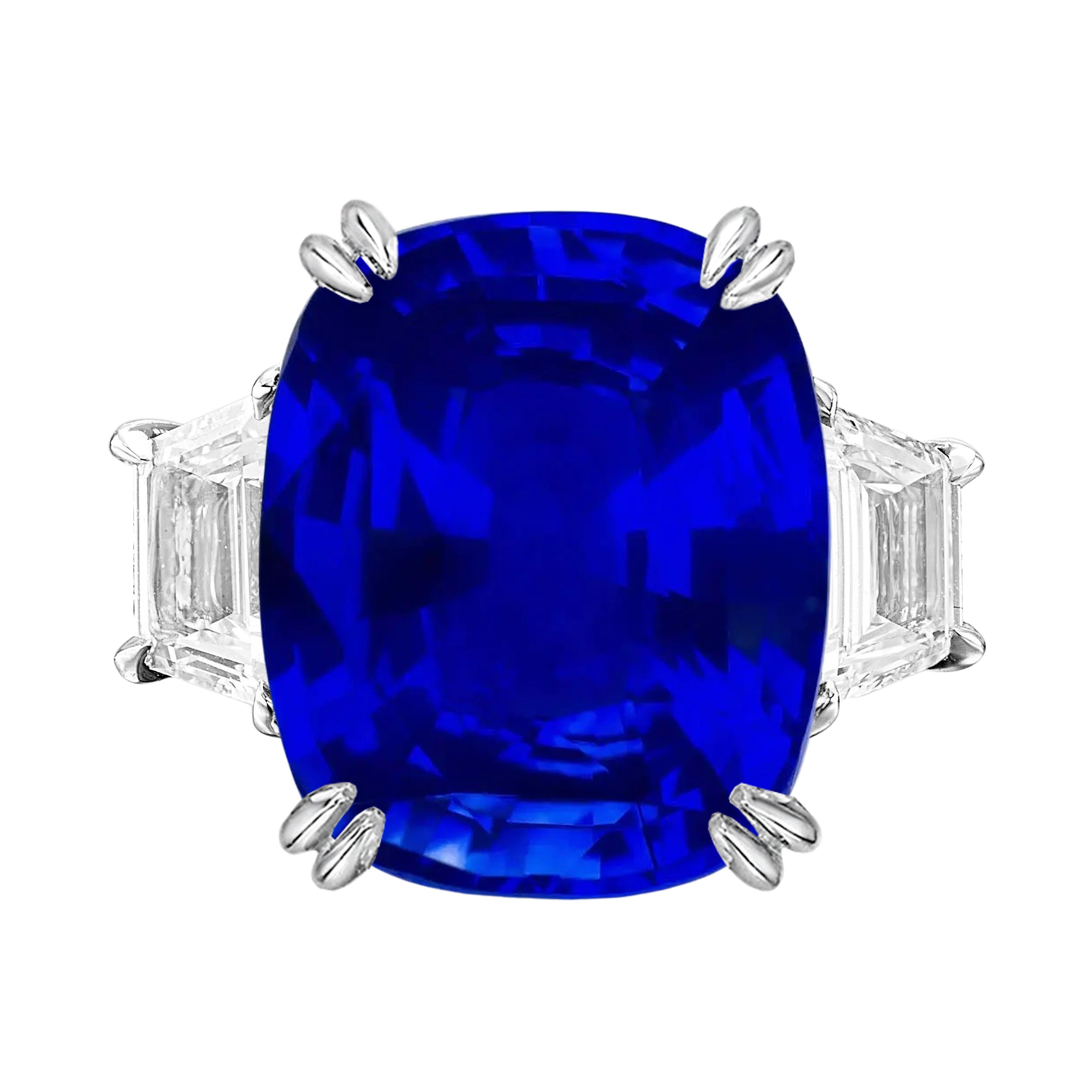 This important ring dating from the mid to late 20th century centers a  antique cushion-cut  sapphire weighing 7 carats, set in platinum and flanked by straight tapezoid diamond . It is accompanied by a report from  SSEF Switzerland Laboratories