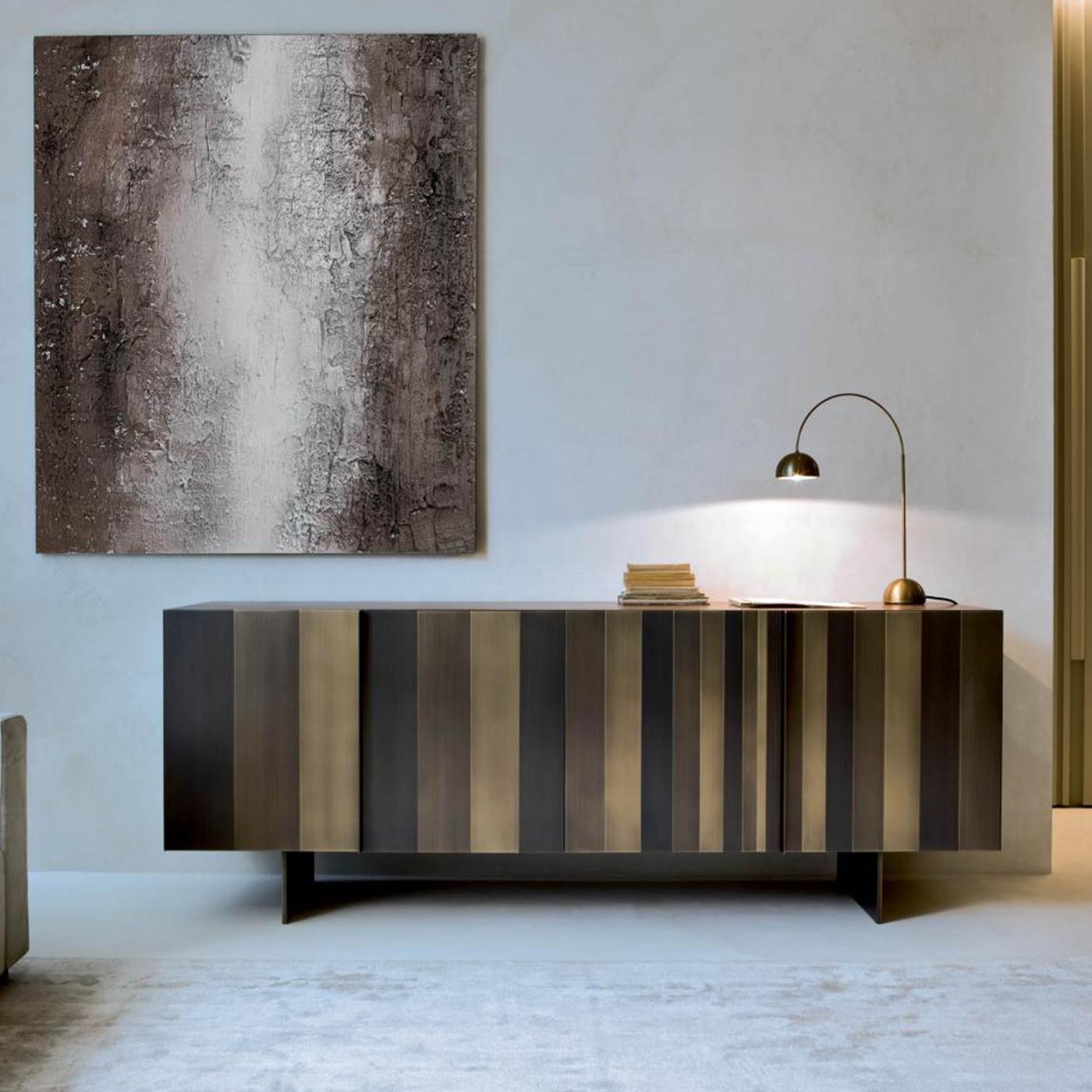 This horizontal sideboard sits atop thin yet sturdy legs and is equipped with four inner drawers. Its sides, doors and legs are covered in metal, while its interior and top have a walnut finish. Its top can also be covered in metal. The use of metal