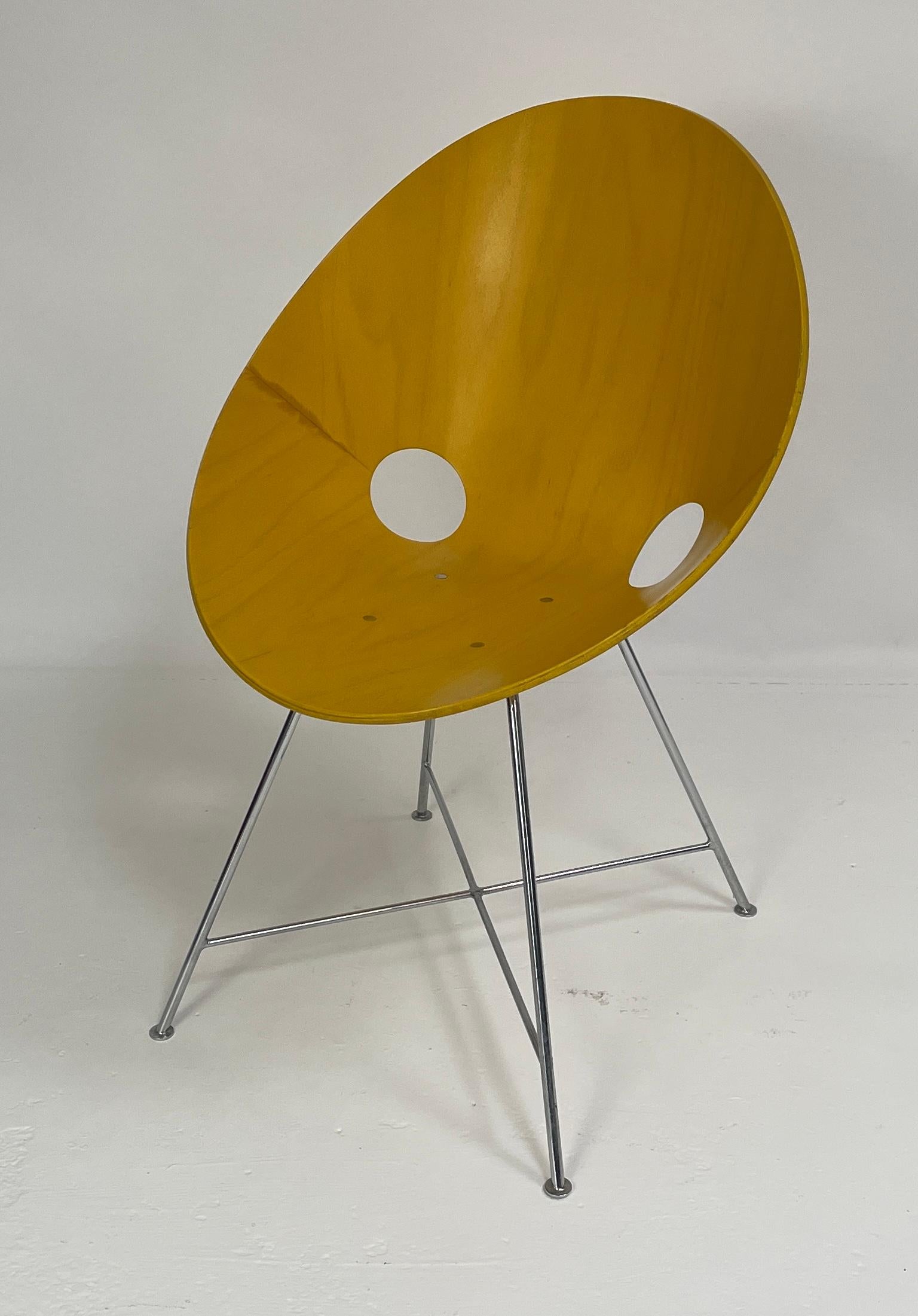 The ST 664 chair designed by Eddie Harlis in 1954. Thonet manufactured the chairs in Germany. These chairs are no longer produced. The chair has a yellow stained finish and are made from bent plywood (beech). The legs are chromed steel. In good