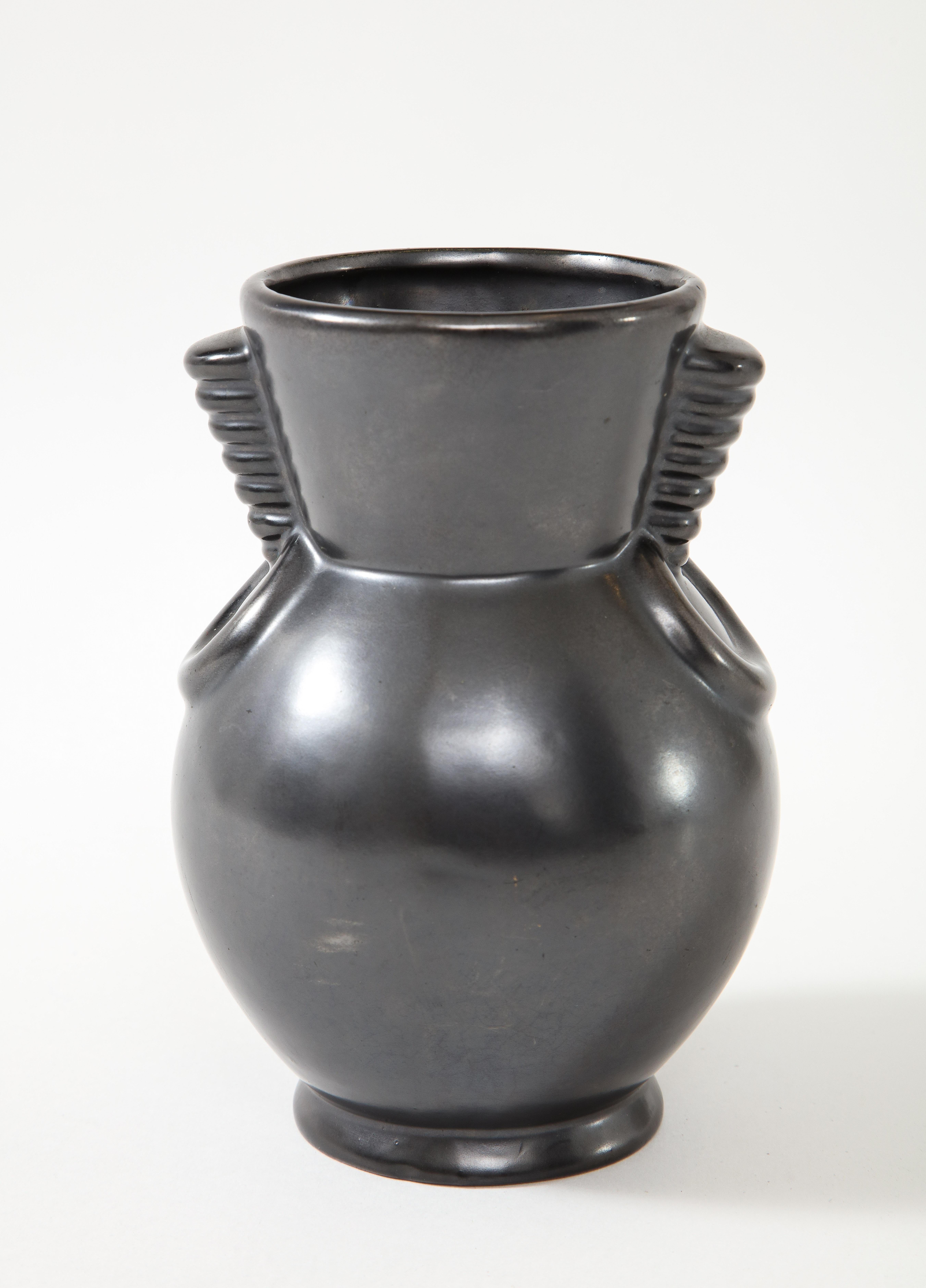 St. Clement, B. Leyalle, matte back vase, France, c. 1930-40's, signed & no.
Ceramic
Measures: Height 7 diameter 5.25 inches.