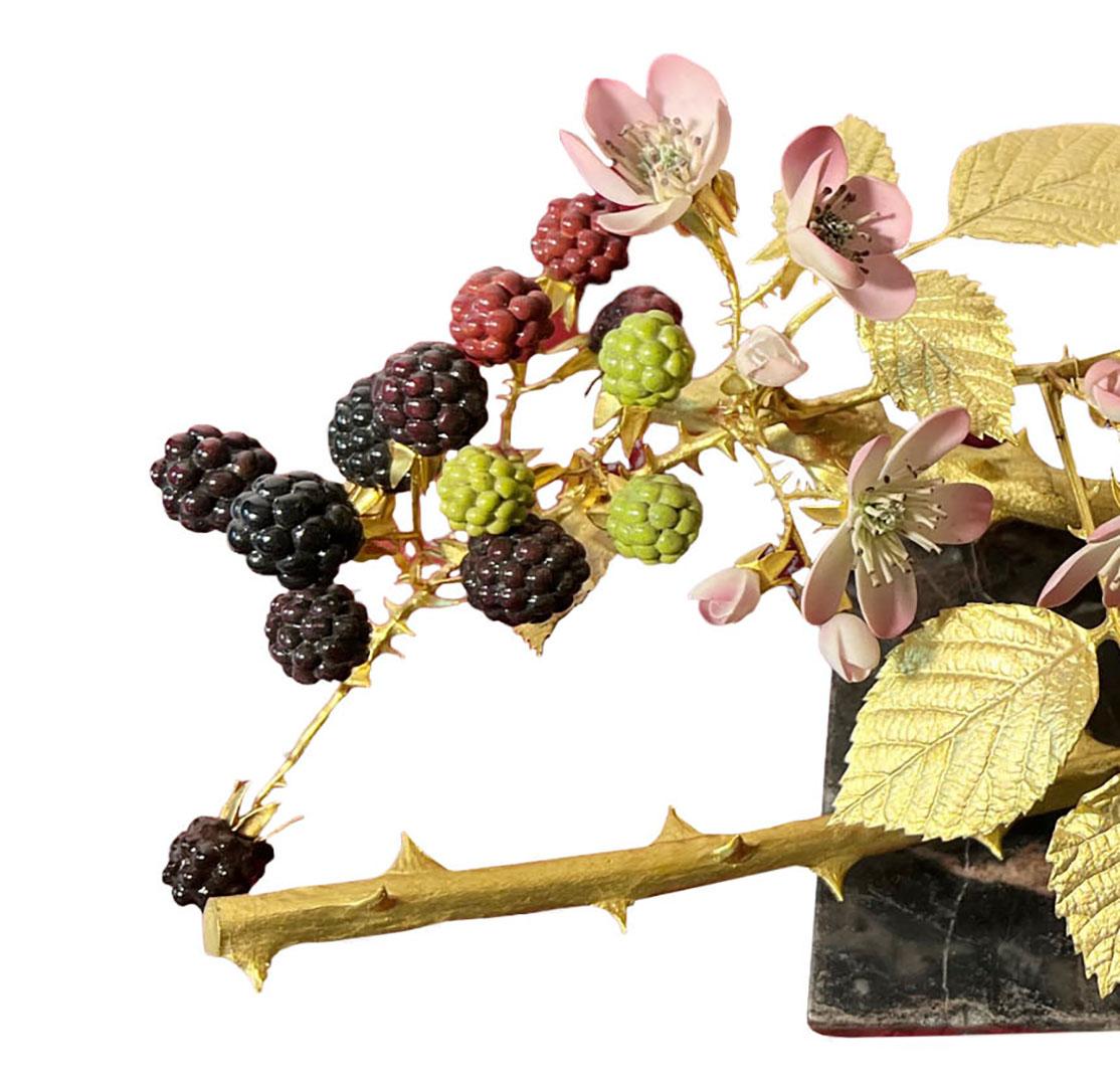 R. Van Ruyckevelt, St. Denis gilded and decorated porcelain sculpture of a black raspberry branch. Set on a rectangular marble base. Malvern, England, 20th century.