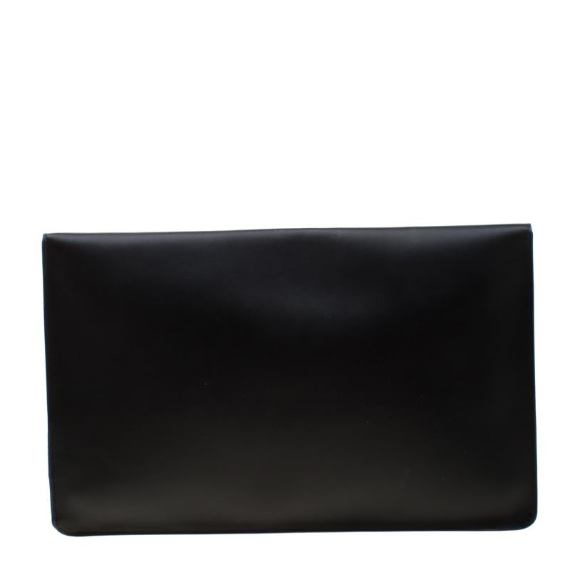Simple and structured in design this pochette from S.T. Dupont is crafted from black leather. A front flap closure opens to a leather lined interior that has enough room to carry your essentials. This sleek creation can be easily carried in your