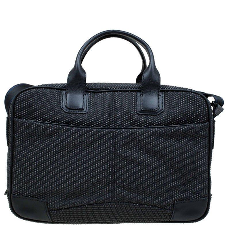 S.T. Dupont designs accessories that stand up to the demands of everyday life. This laptop bag has been crafted in black fabric with an all over textured pattern. It has an adjustable shoulder strap, double top handles and an external slide pocket.