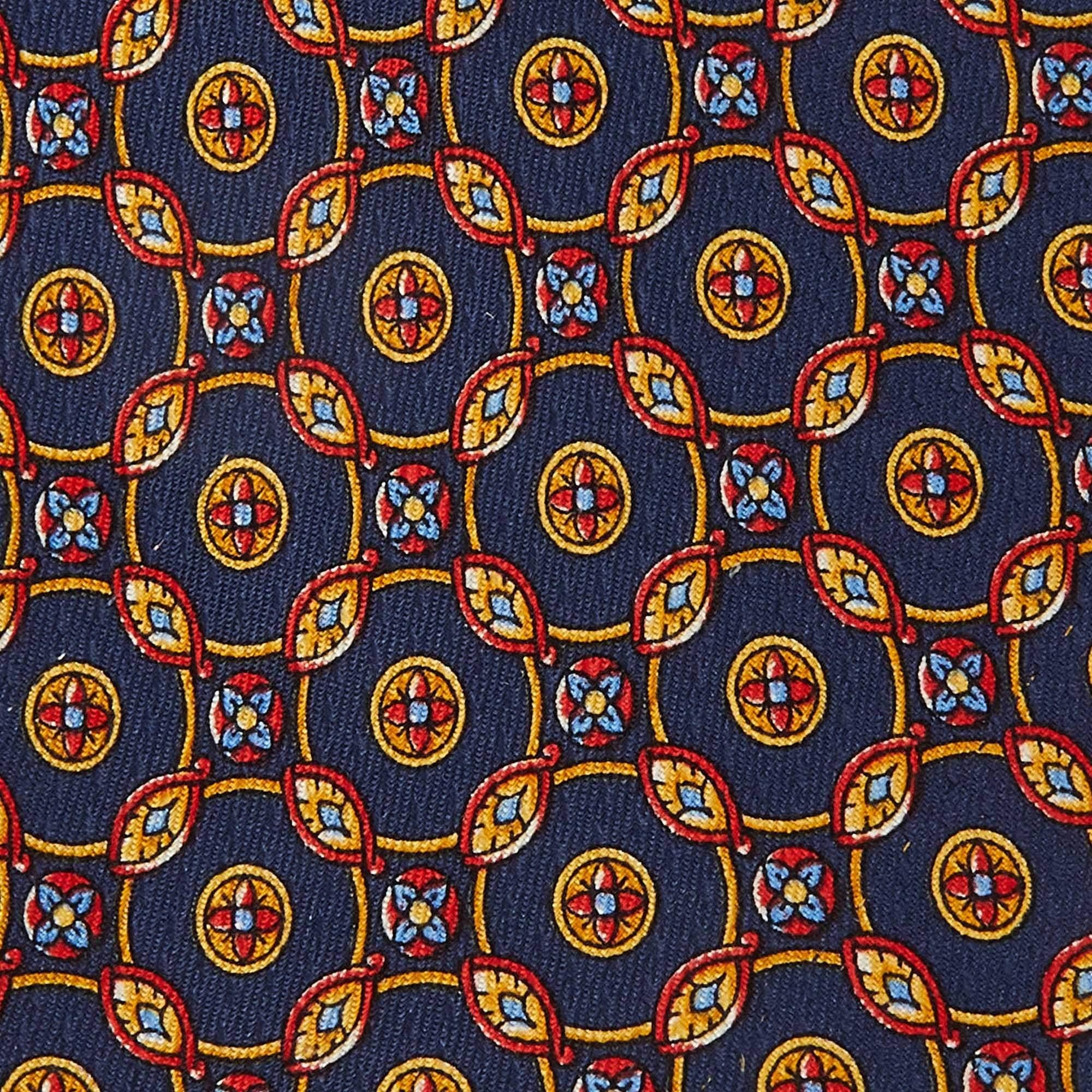 Made of silk  this S.T. Dupont navy blue tie for men has notable prints all over. This finely tailored accessory will add a charming finish.
