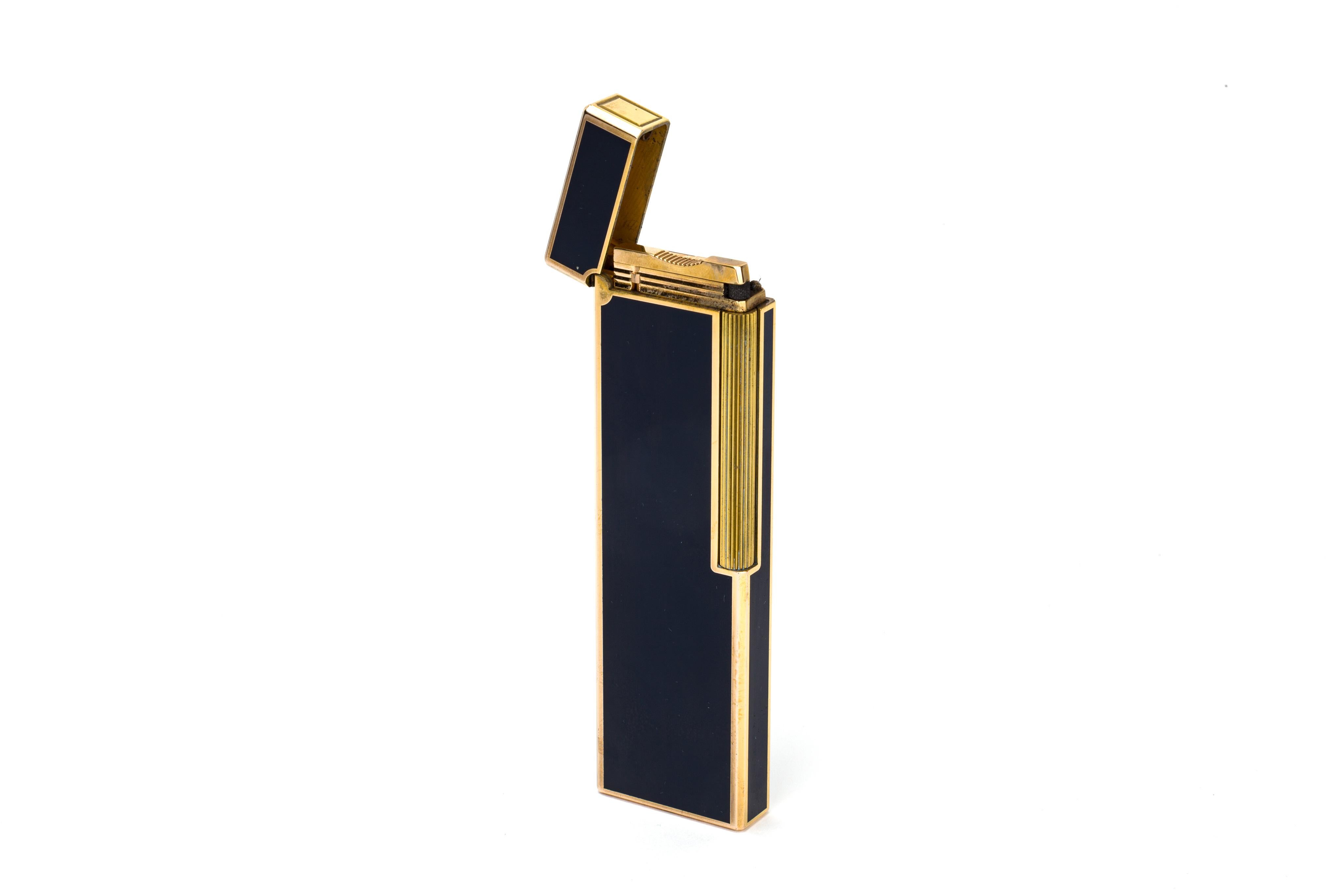 A gorgeous table-lighter from S.T. Dupont, done in a baked cerulean enamel and gilt edges. 

Lighter is in full working condition.