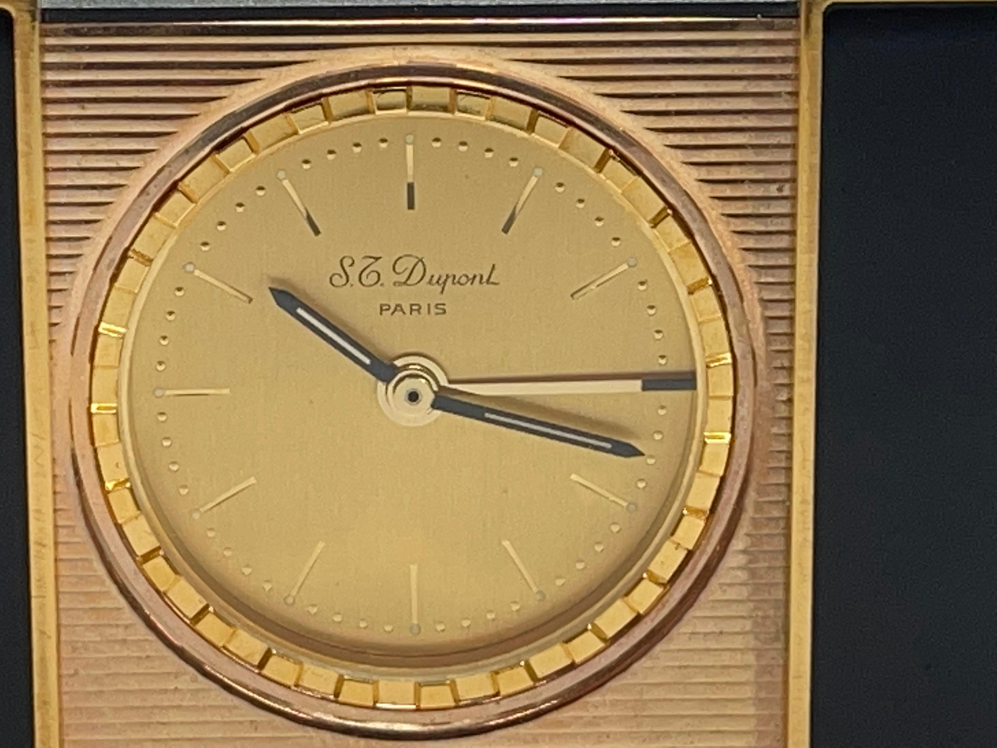 Pretty black lacquer travel by S.T. Dupont. Made in France the clock is battery powered and keeping time nicely. The alarm function I cannot get to operate. It is adjusted by rotating the ring on the face. The clock slides open and closed. In