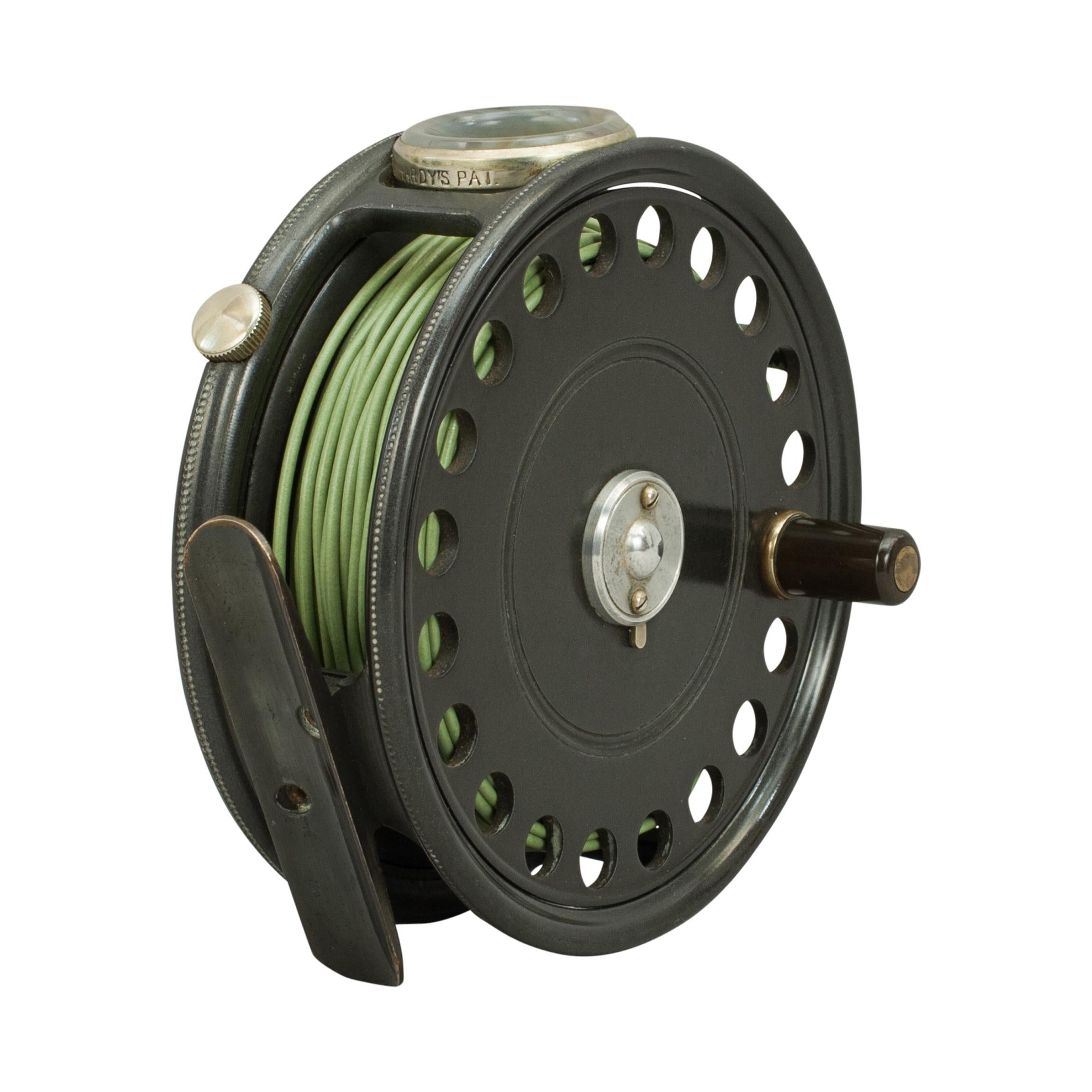 St George fly fishing reel by Hardy Bros.
This is a Hardy 'Saint George' alloy trout fly reel, it has a smooth agate line guide, 2 screw latch, rim tension regulator, ribbed brass foot, check mechanism, black handle and retains the original grey