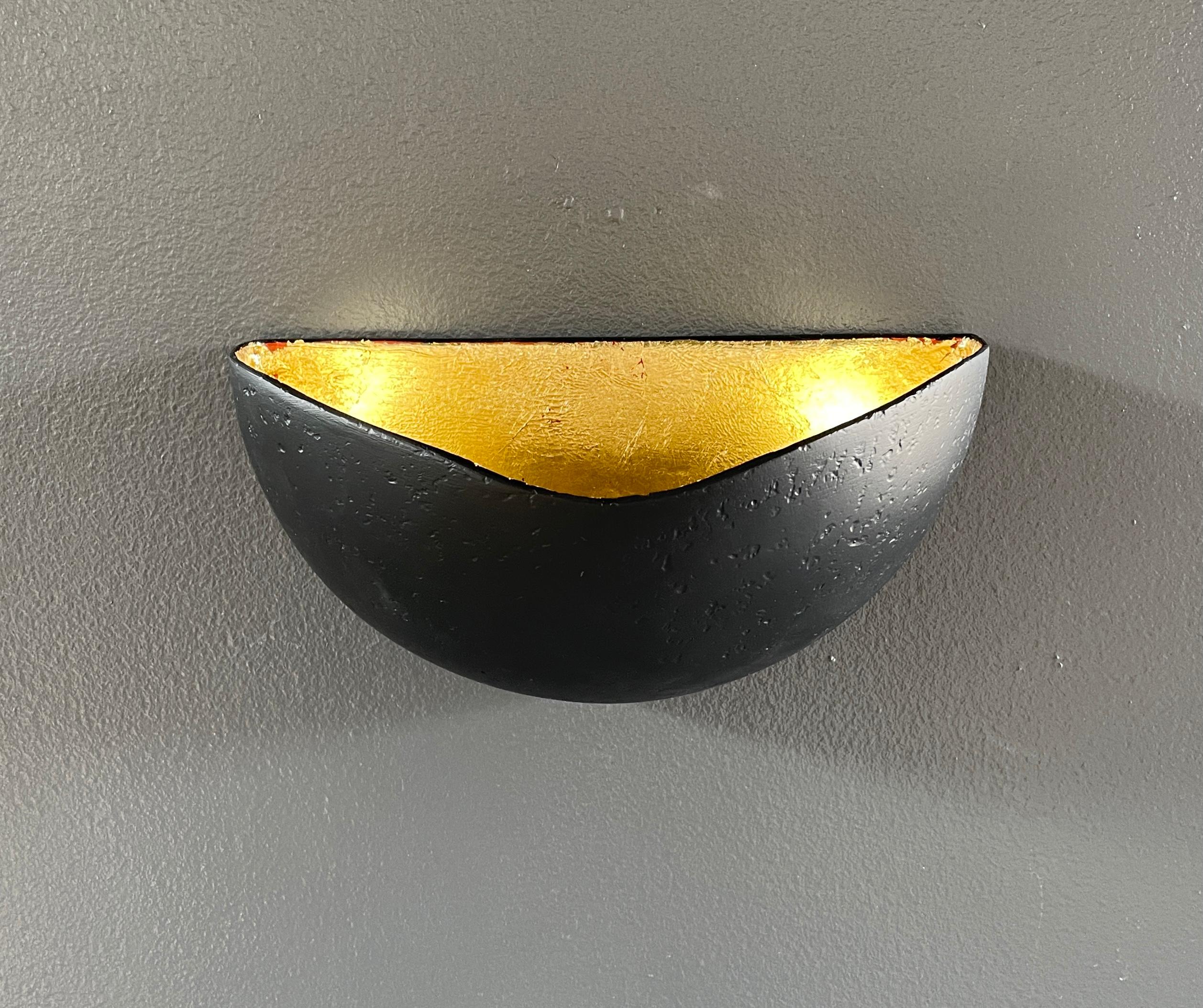 Designed to complement our St Germain chandelier, these wall sconces have a half dome shape and are handcrafted with our signature plaster of Paris finish. They provide an indirect uplight. A gold leaf or a black interior can be specified. The