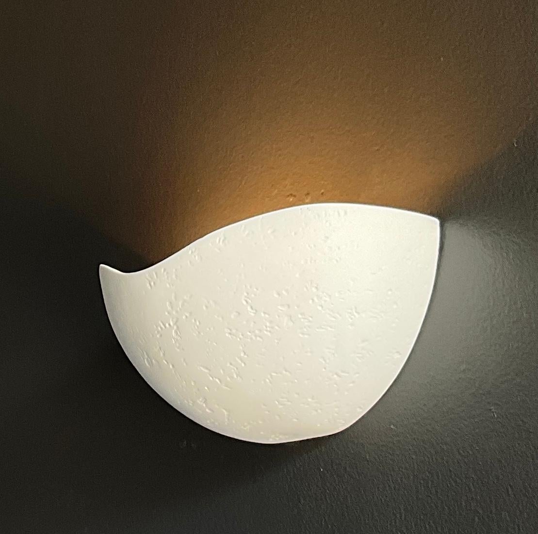 Designed to complement our St Germain chandelier, these wall sconces have a half dome shape and are handcrafted with our signature plaster of Paris finish. They provide an indirect uplight. A gold leaf or a pure white interior can be specified. The