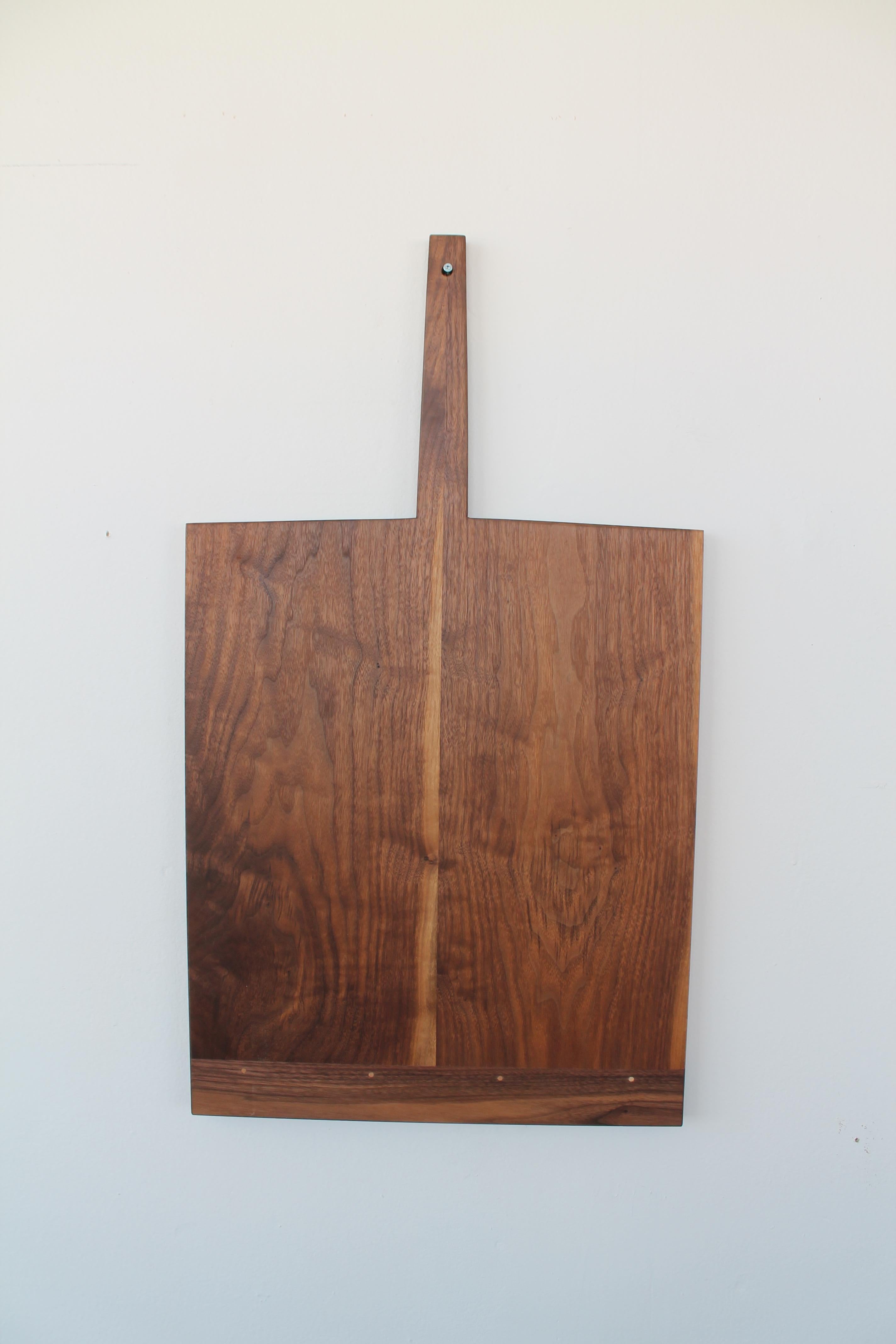 The St Helena Tray is a piece that will complete your kitchen.  Hang it from a pot rack, or simply lean it against the back splash and the warm walnut and hand shaped minimalist form will lend comfort and elegance.  When guests arrive, even the most