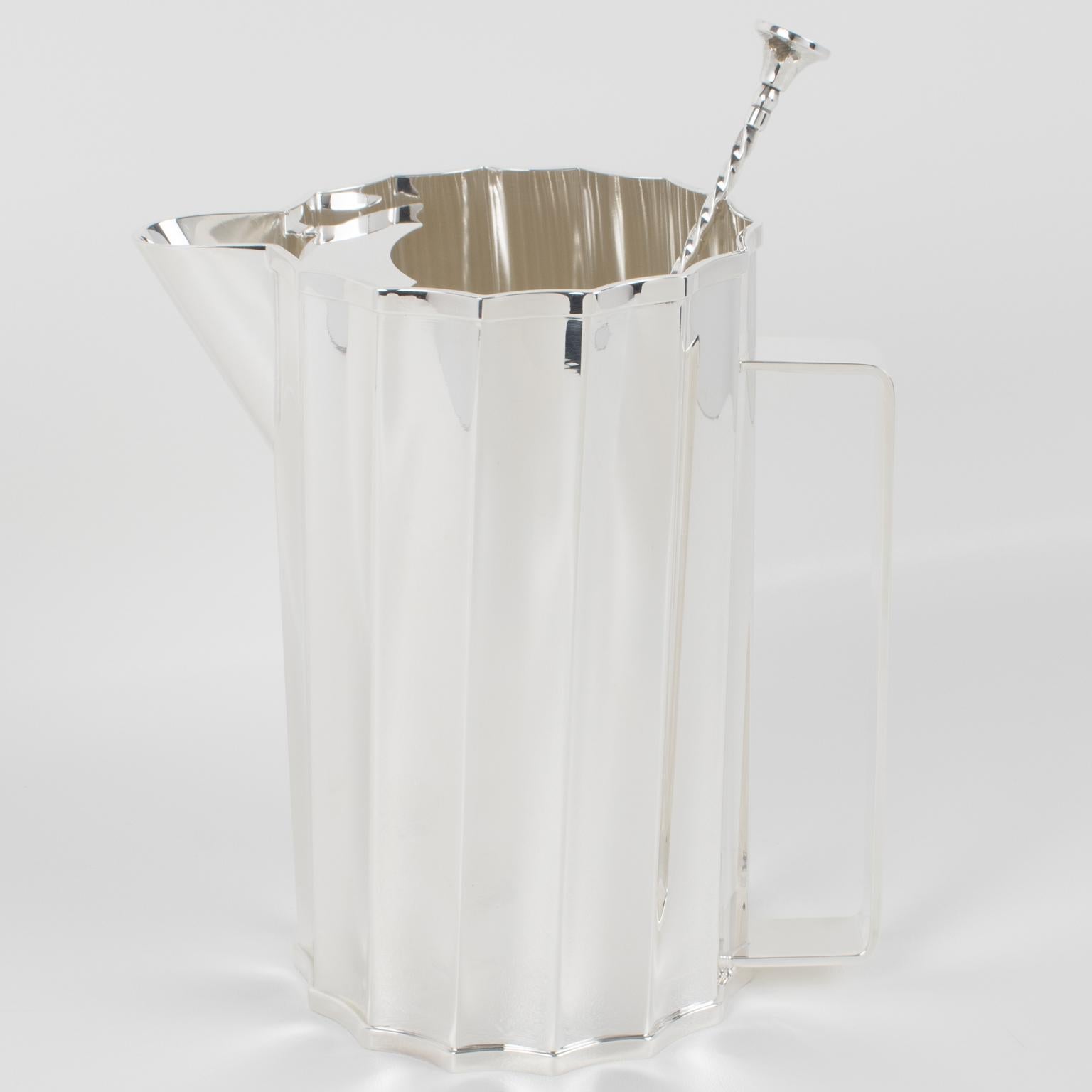 Stylish modernist Art Deco-inspired silver plate barware cocktail or Martini pitcher designed by St James, Brazil. This drink jug has a minimalist chic design, featuring a geometric twisted scalloped sunburst shape, a sturdy handle, and an ice lip.