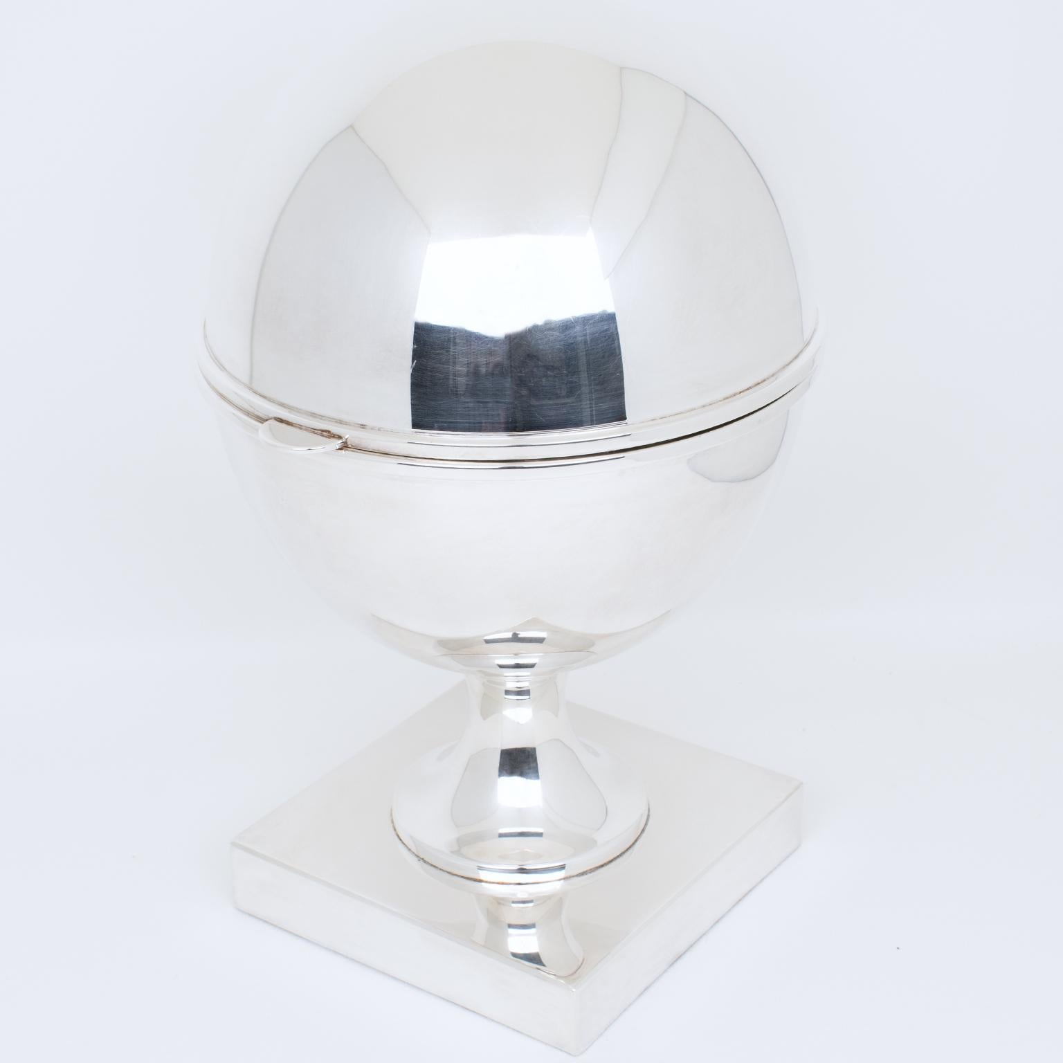 This stylish and large egg or ovoid-shaped silver plate caviar bowl, serving dish, or caviar chiller is hallmarked St James, made in Brazil with a coat of arms on the square base. This piece was crafted circa 1980s. It is sculptural on all sides and