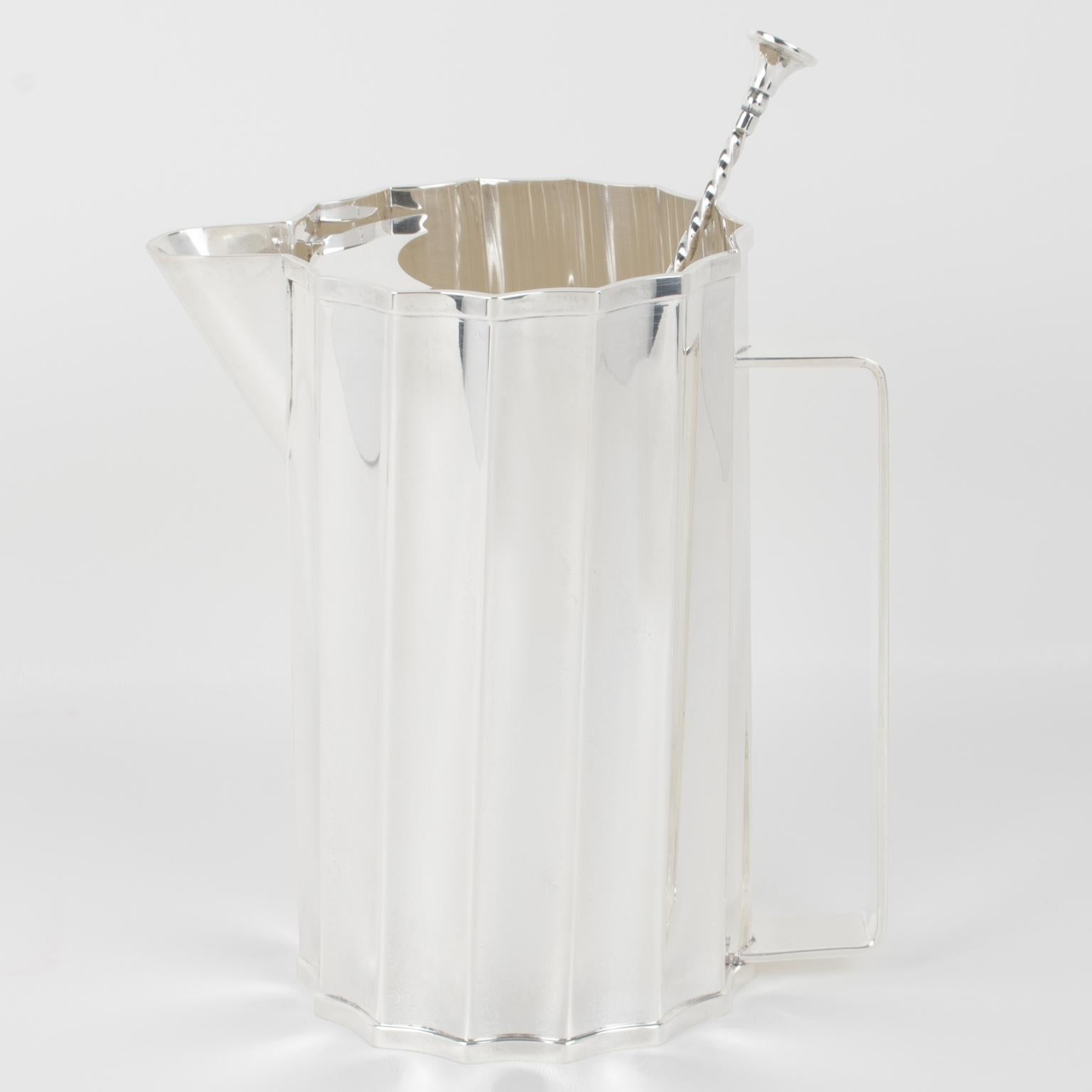 Boost your cocktail experience with this exquisite Art Deco-inspired silver-plated pitcher, a rare masterpiece of modernist barware designed by St. James, Brazil. With its striking geometric scalloped sunburst shape, sleek twisted contours, and