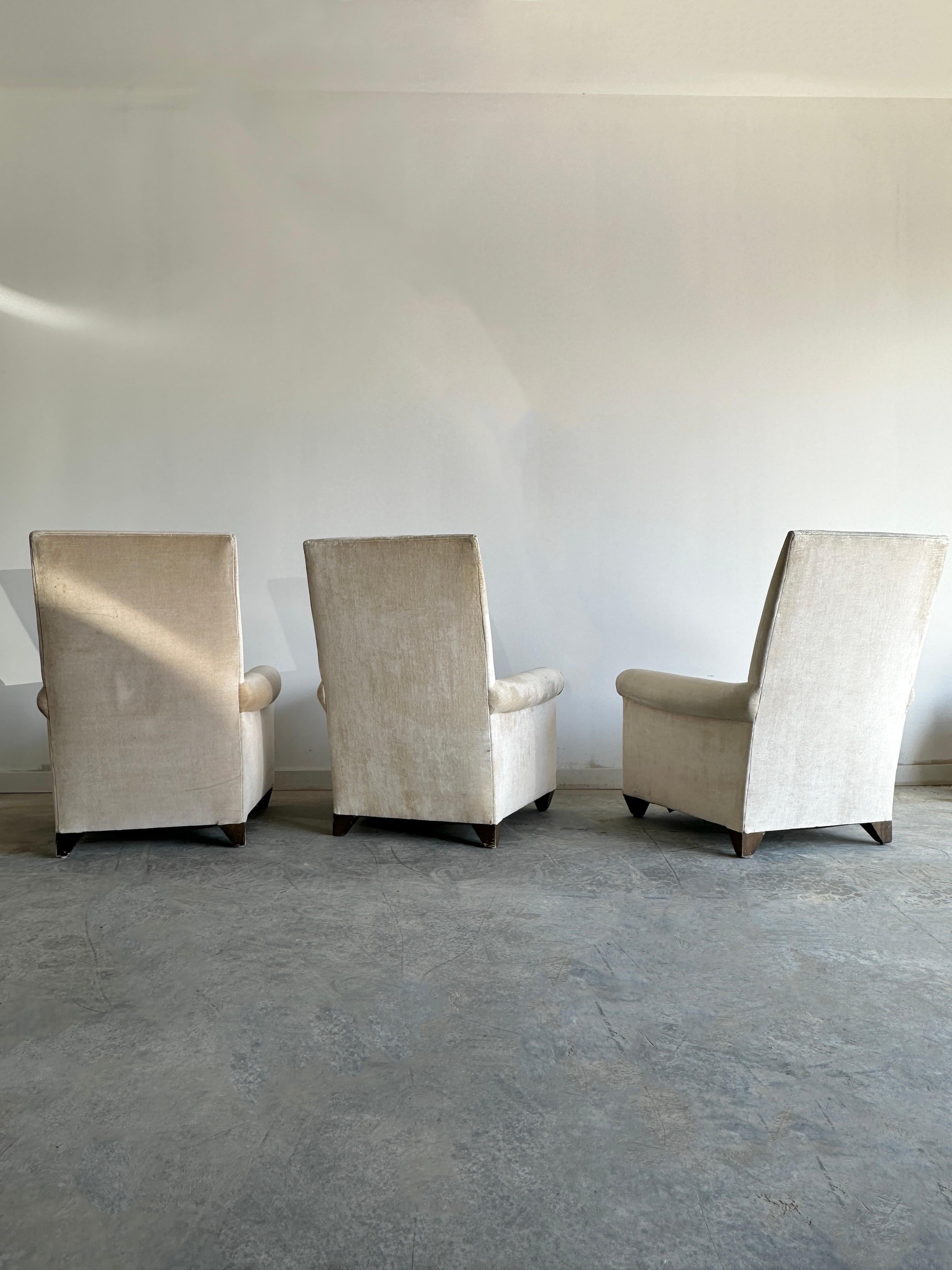 Three elegant and very comfortable arm chairs that featuring deep cushions, tall back and high quality textured velvet fabric. The chairs have a sleek and modern design that reflects the style of the their creator, Angelo Donghia, who was known for
