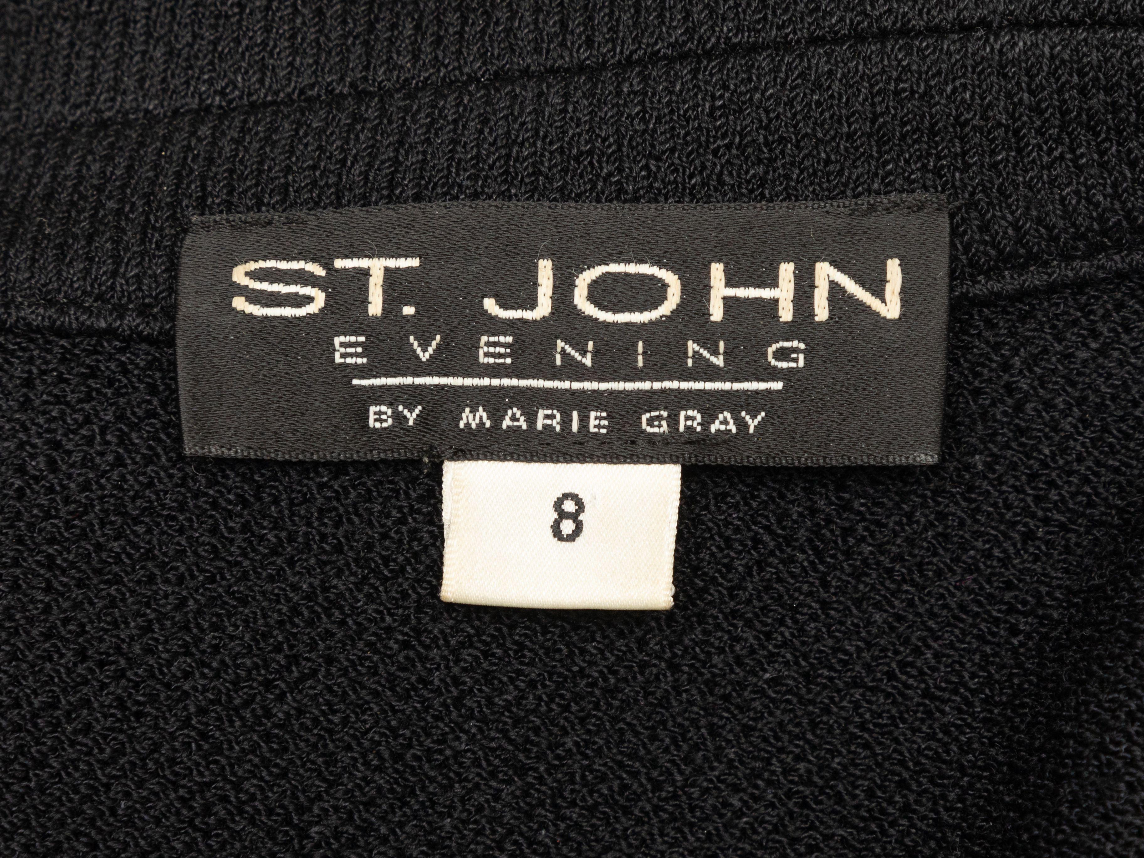 Product Details: Black knit blazer by St. John. Rhinestone trim embellishments throughout. Notched collar. Dual flap pockets at hips. Rhinestone button closures at center front. 34
