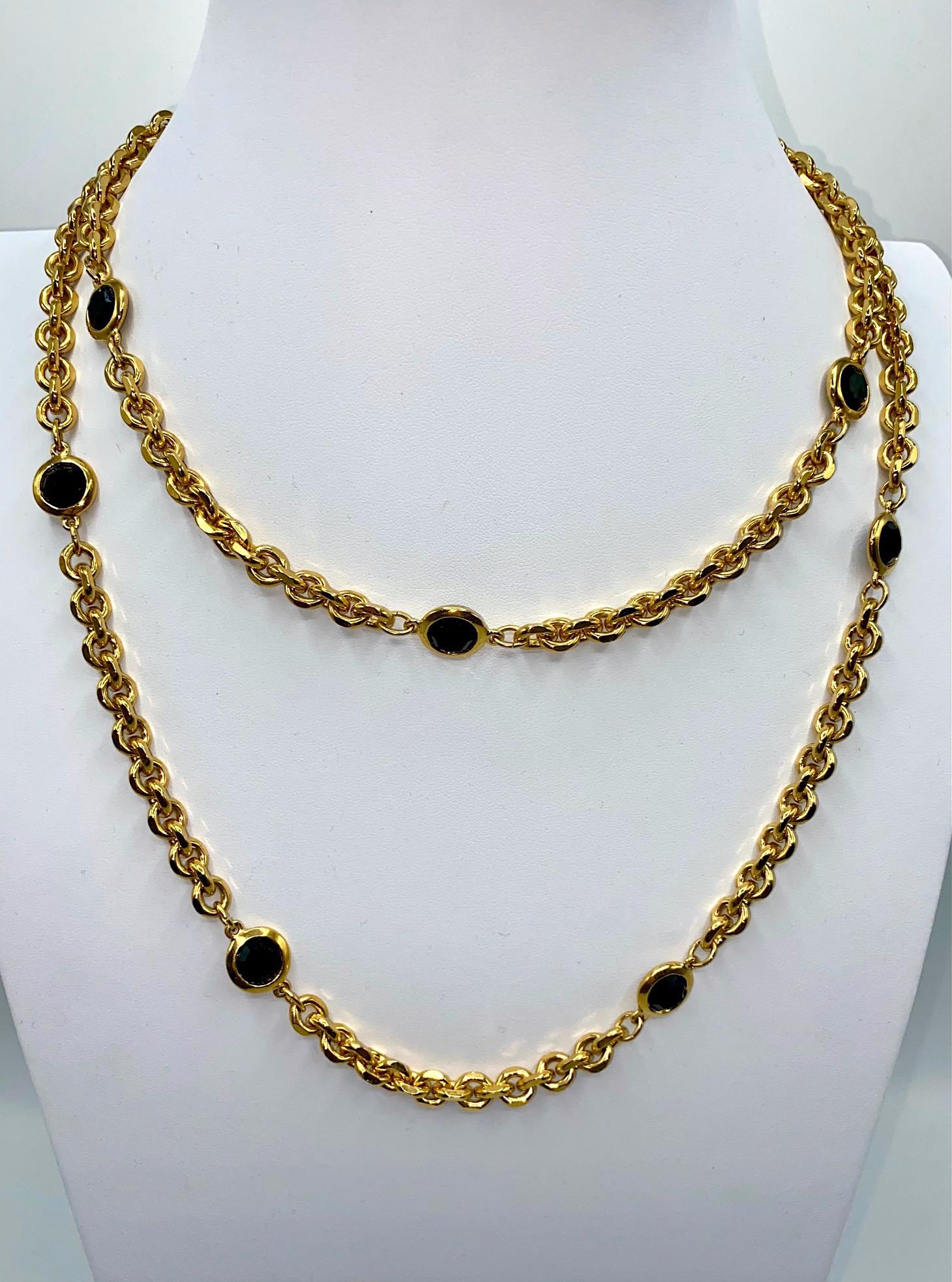 St. John Collection classic long gold chain necklace with bevel set round faceted glass crystal spacers. The chain is a beveled edge cable link in heavy gold plate measuring 8 mm / .32 of an inch wide and 48 inches long. Easily worn long or doubled