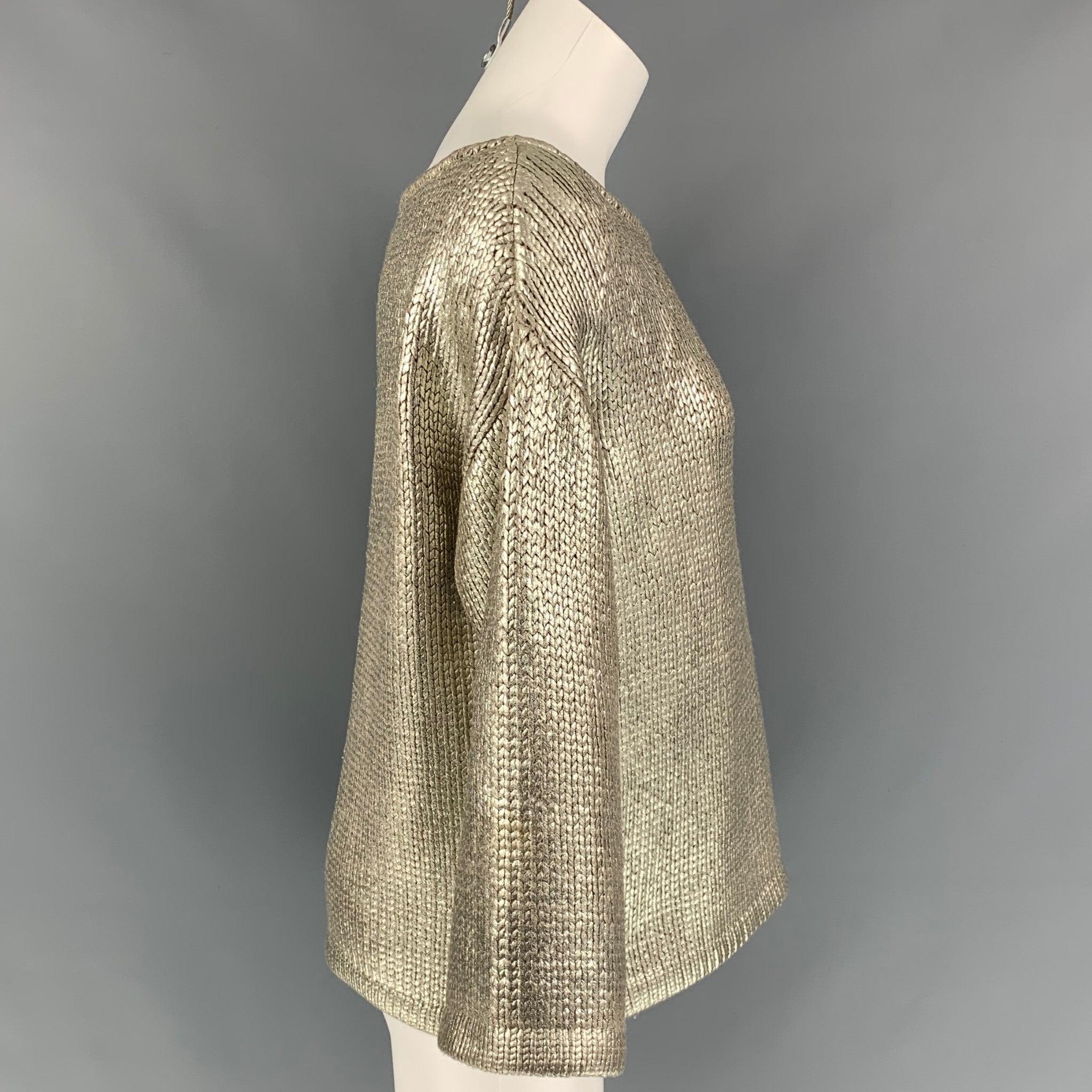 ST. JOHN COUTURE sweater comes in a silver knitted wool featuring a loose fit and a scoop neck. Made in USA.
 Very Good Pre-Owned Condition. 
 

 Marked:  M 
 

 Measurements: 
  
 Shoulder: 21 inches Bust: 42 inches Sleeve: 17.5 inches Length: 22