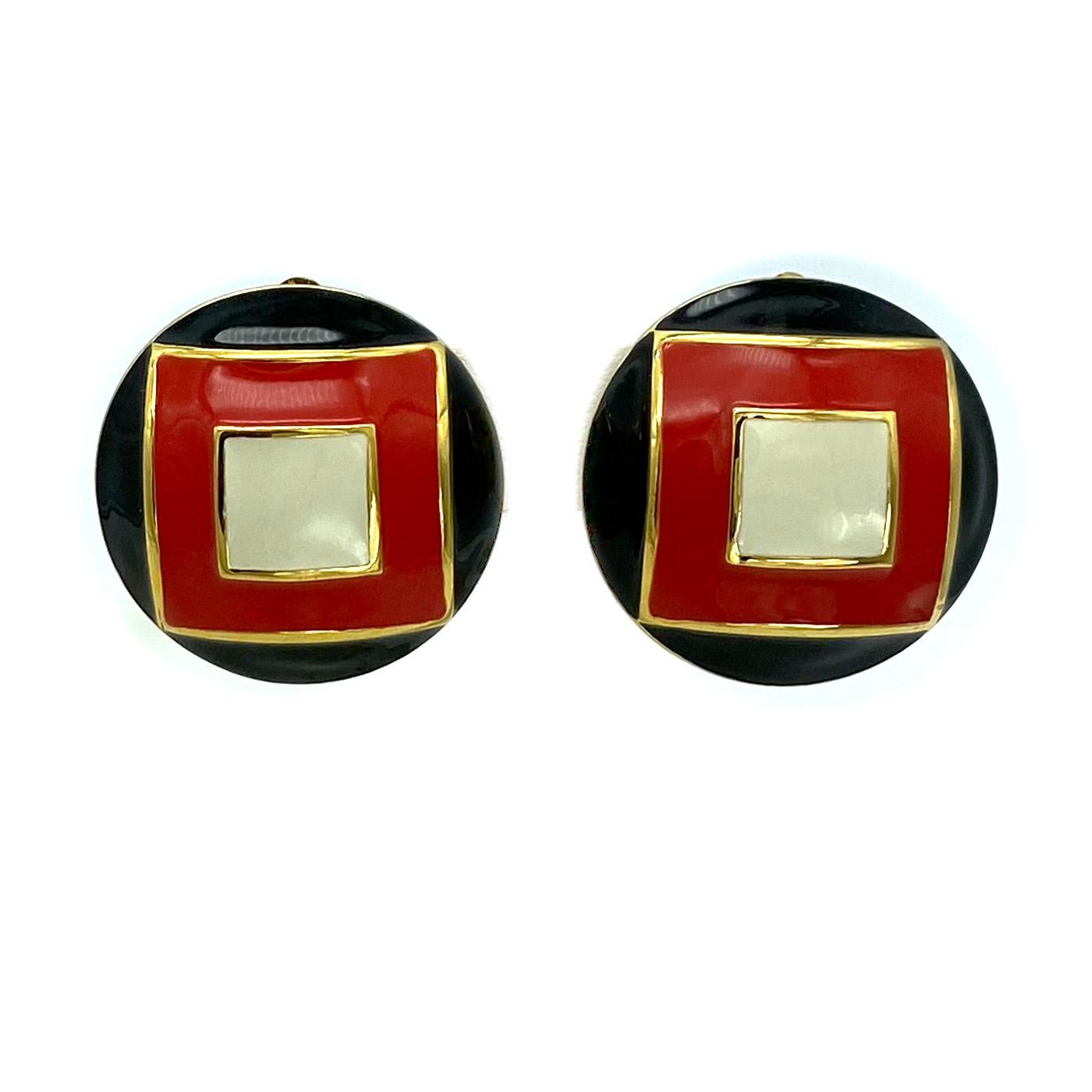 This pair of St John enamel clip earrings in great condition. Like new! They are patterned with a small white enamel square in a medium red enamel square set in a black enamel circular background. 

Our vintage jewelry collection and original