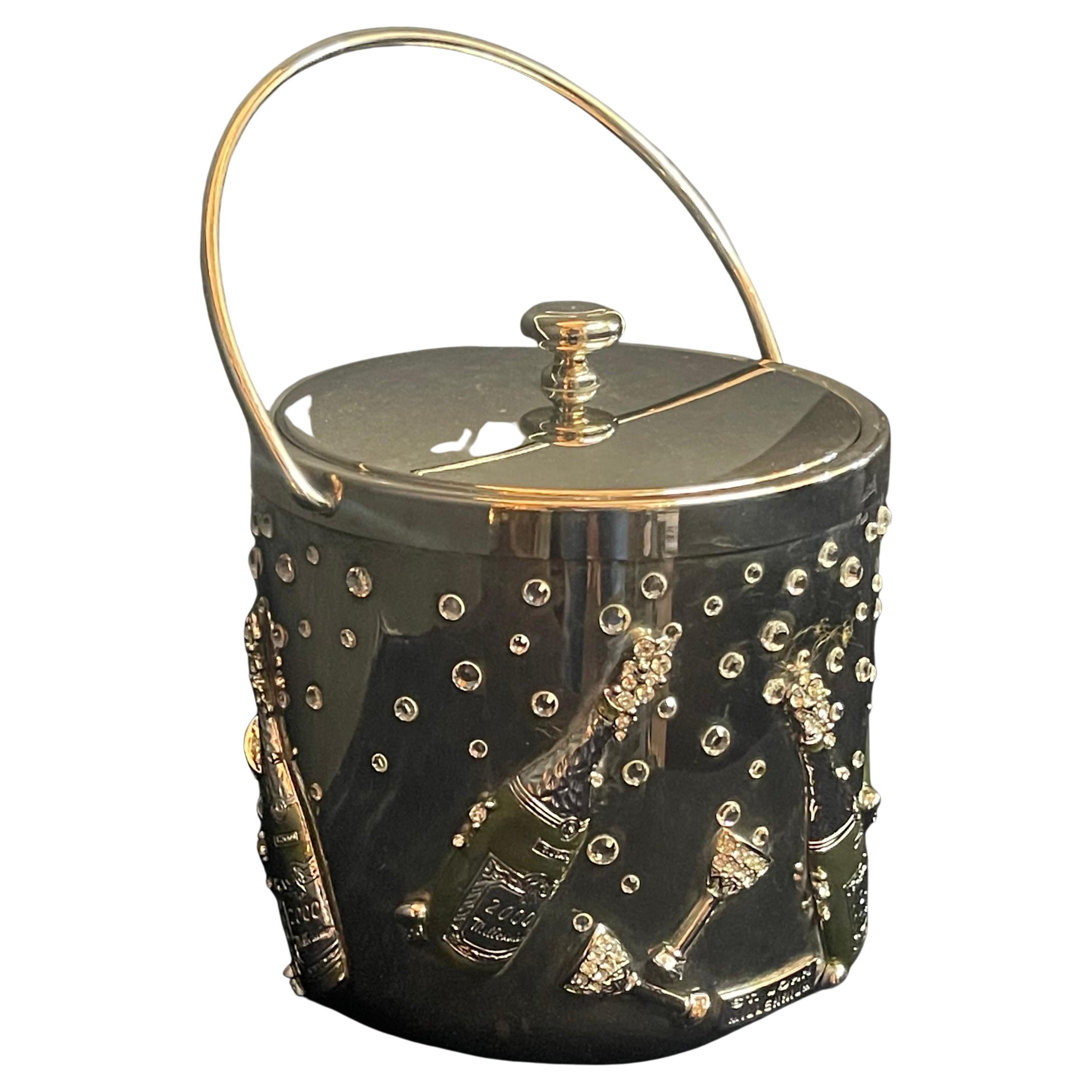 A rare and wonderful St. John home millennium swarovski encrusted crystal in the design of champagne bottles & glasses with bubbles. This stunning ice bucket / cooler is 10