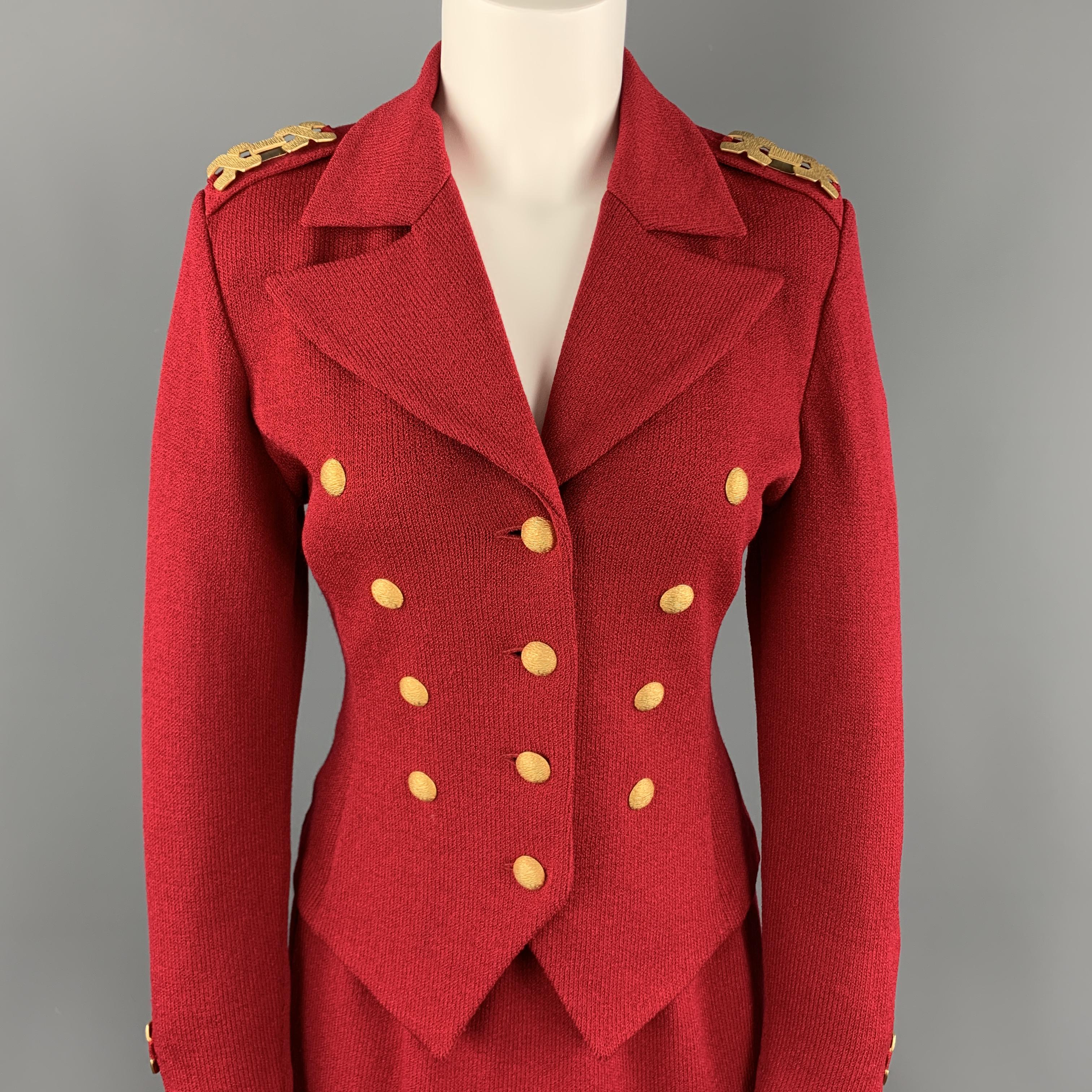 Vintage ST. JOHN skirt suit comes in rich red knit and includes a double breasted jacket with pointed lapel, textured yellow gold tone buttons and epaulet hardware wih matching skirt. Made in USA.

Excellent Pre-Owned Condition.
Marked: