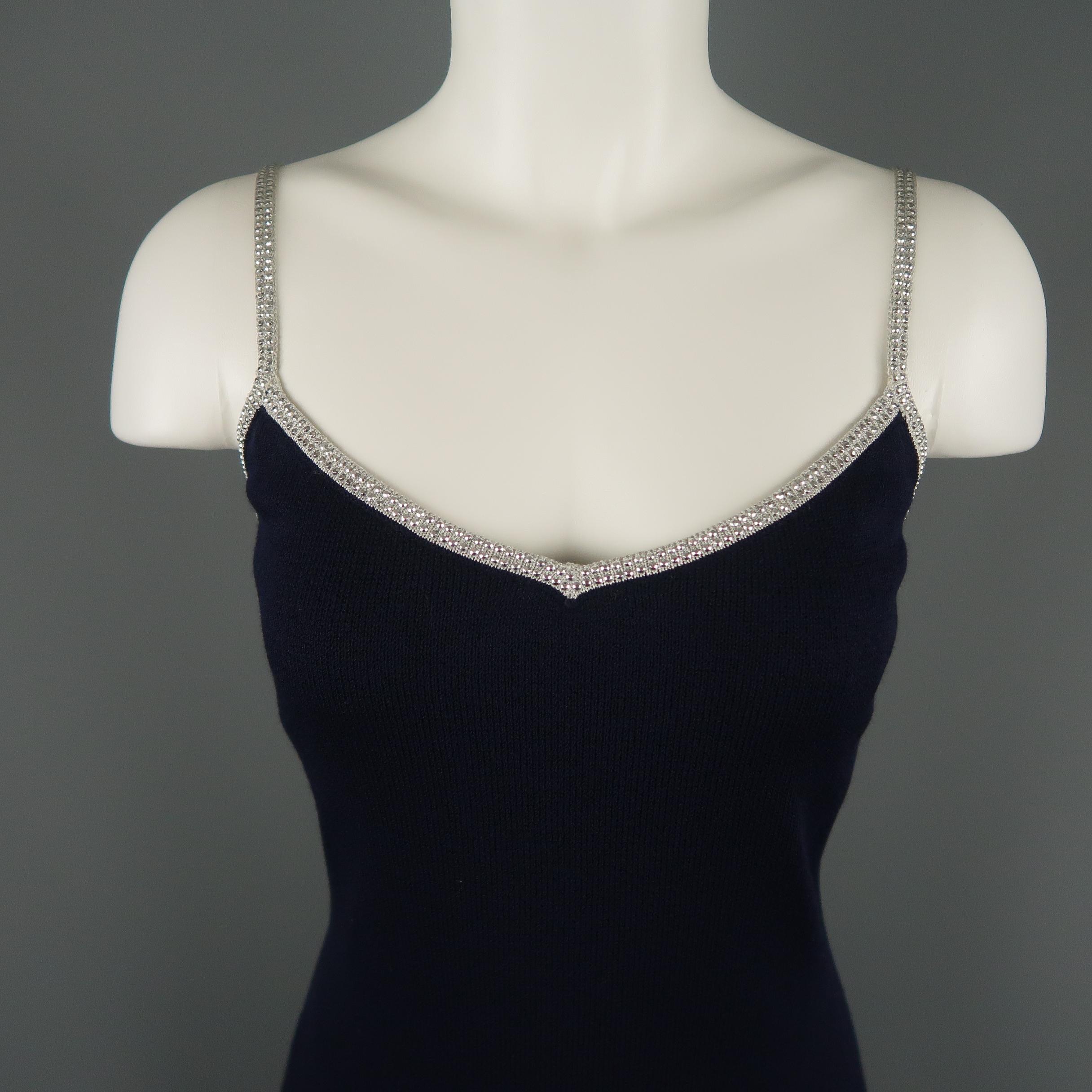 ST. JOHN cocktail dress comes in a navy knit with a sheath slip style silhouette and silver knit trim and spaghetti straps with rhinestones. Made in USA.
 
Excellent Pre-Owned Condition.
Marked: 8
 
Measurements:
 
Shoulder: 12 in.
Bust: 36