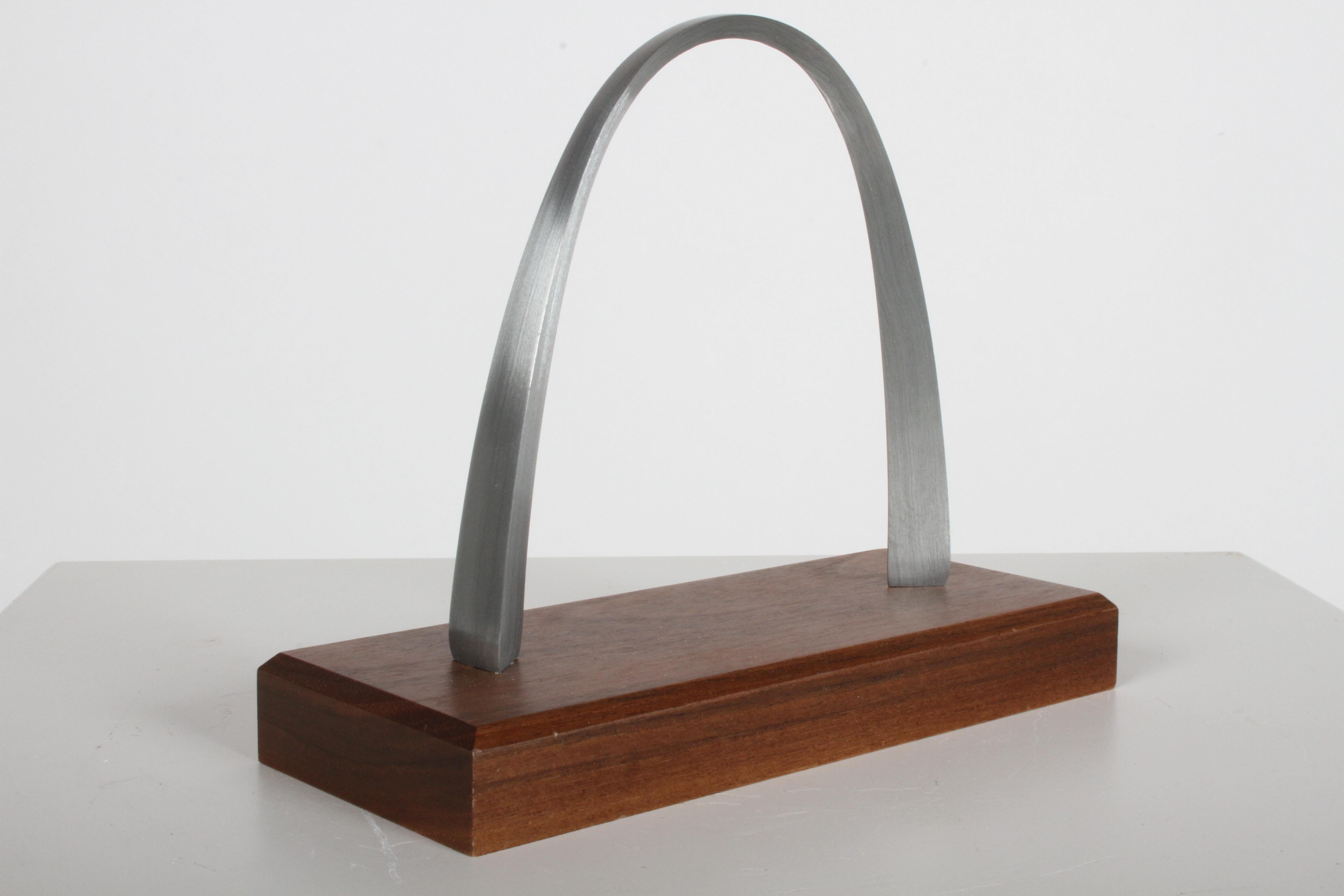 New old stock stainless steel miniature model or sculpture of the St. Louis Arch on walnut base. These models are based on the St. Louis Gateway Arch designed by Eero Saarinen that was completed in 1965.

The Gateway Arch is a 630-foot monument in