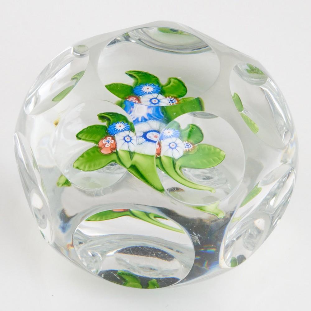 Heading : A St Louis Nosegay Lampwork Paperweight c1850
Date : c1850
Origin : France
Features : Four lampwork and millefiori flowers, stems and leaves on a clear ground with window and facet cuts
Marks : None
Type : Lead
Size : 4.9cm diameter, 3.9cm