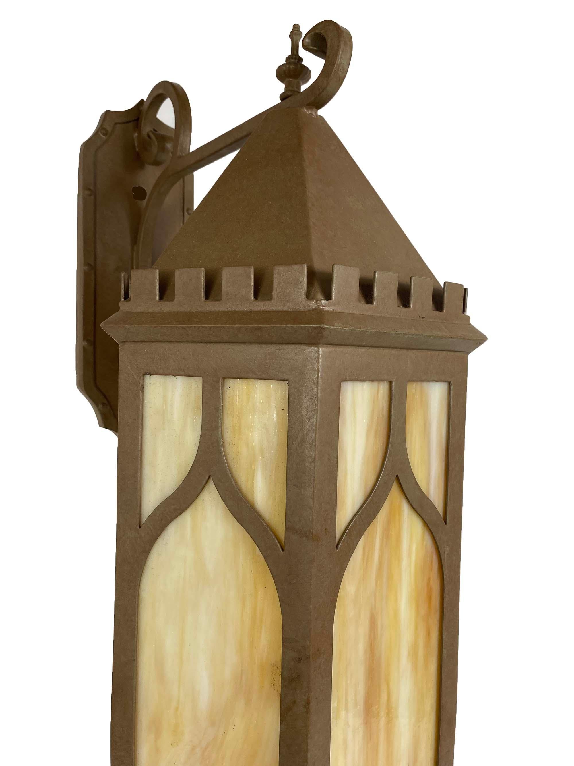 This wrought iron Gothic Lantern was made for a private chapel in France. We also made matching pendants that are availalble. The Bronze finish and Honey opal glass give a warm glow when lighted. All the details are typical of the gothic period. The