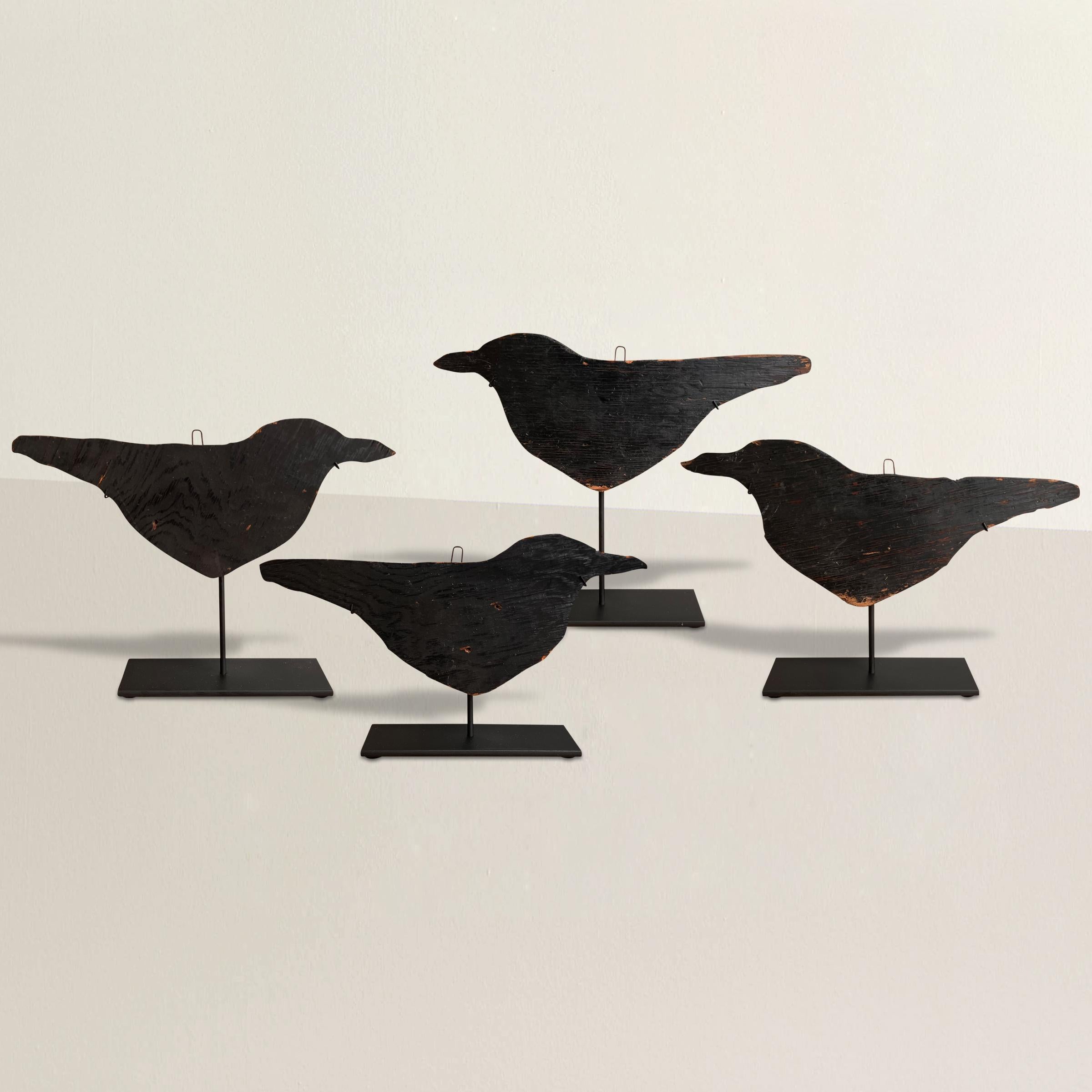 A charming murder of early 20th century American Folk Art crow decoys carved from plywood and painted black, and mounted on custom steel stands. Perfect decor for your country house, or Halloween decorations.