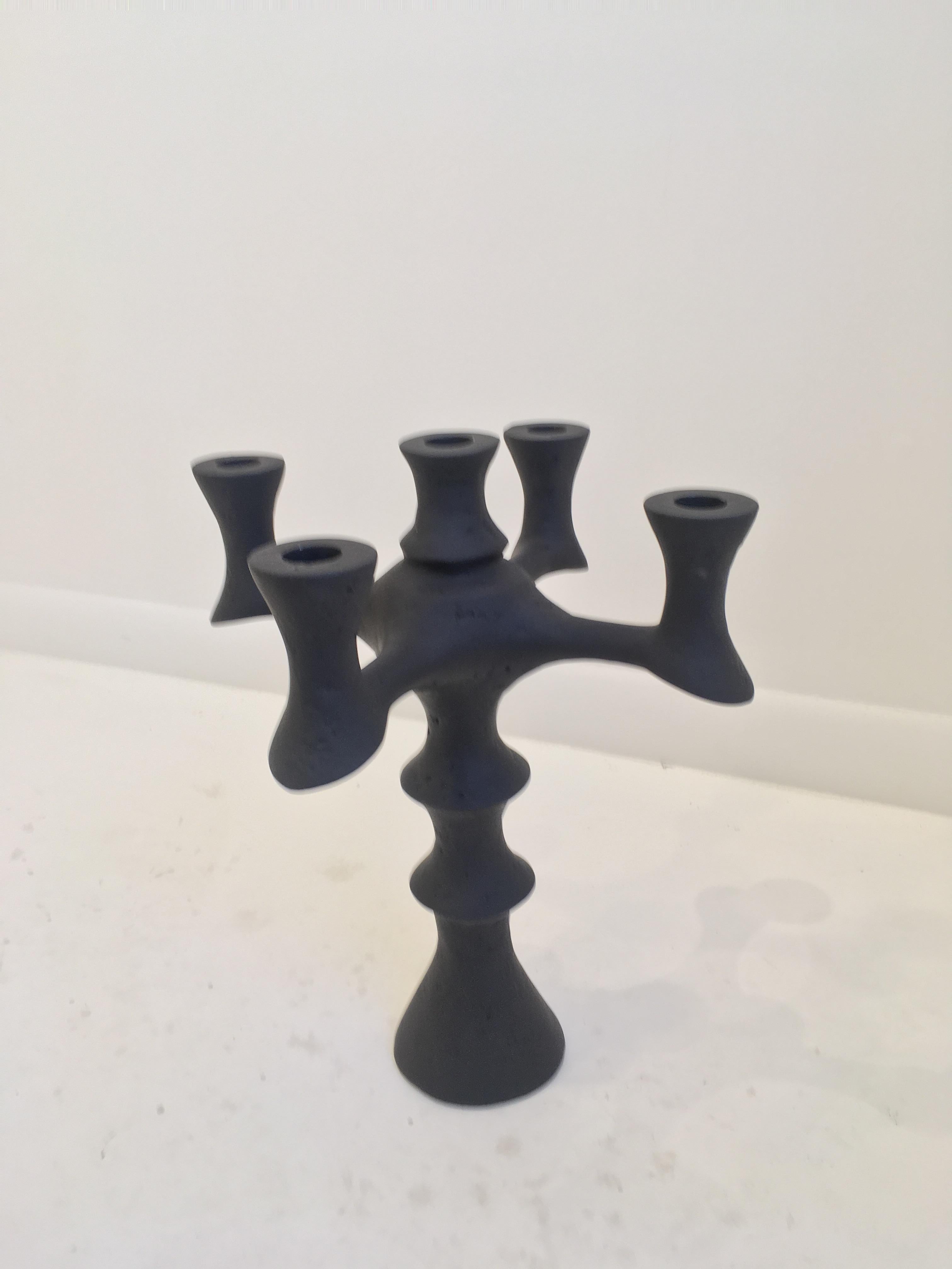 Sculpted plaster of Paris candleholder. A reminiscent of Giacometti's work, this five candleholder has a sleek yet elegant design. With its soft edges and texture it makes for an outstanding centerpiece for any console or table. Candleholders have