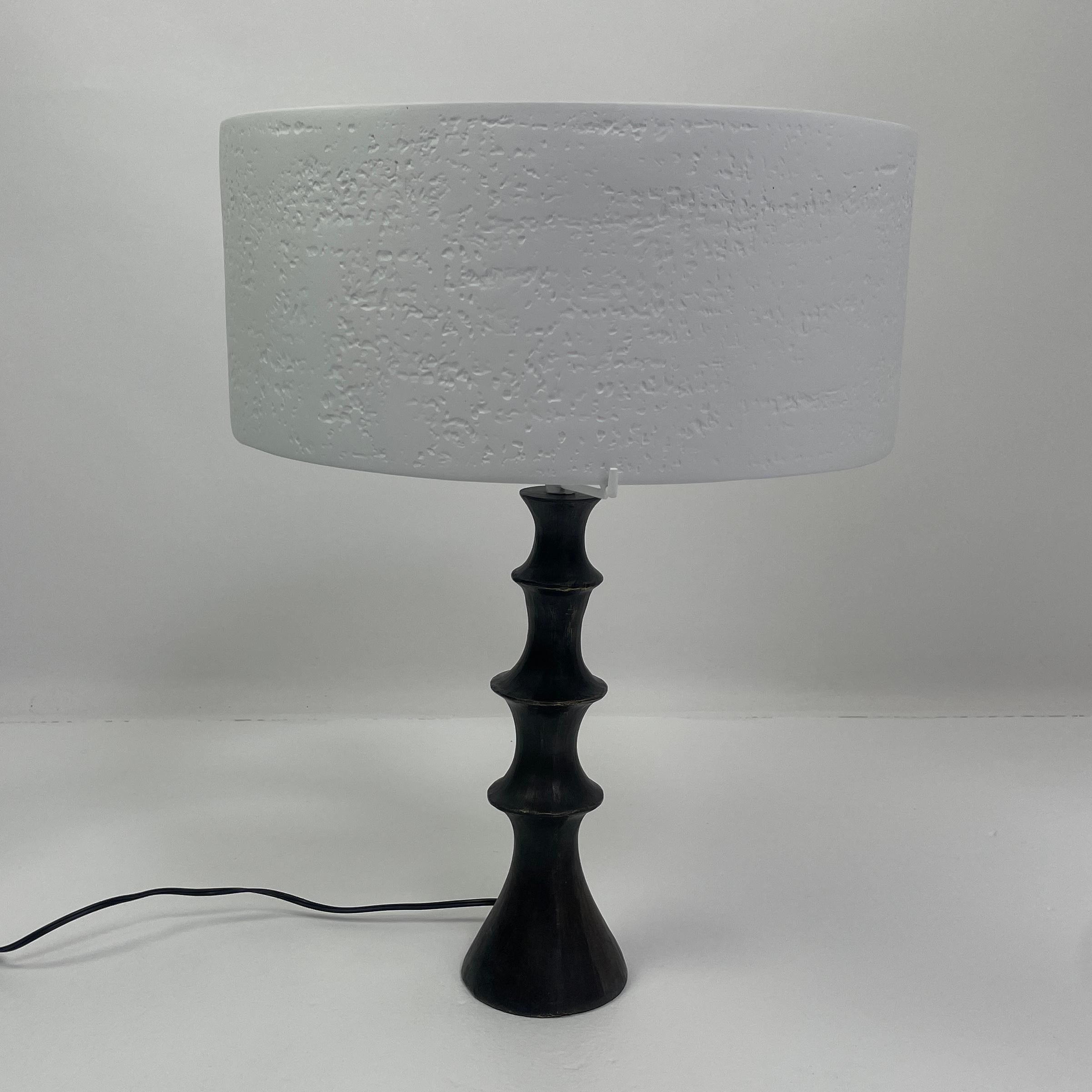 This unique lamp blends bronze and our signature plaster finish to create an elegant statement. The cast bronze base with the plaster shade create a soft diffused light. The light uses low voltage LED bulbs.
