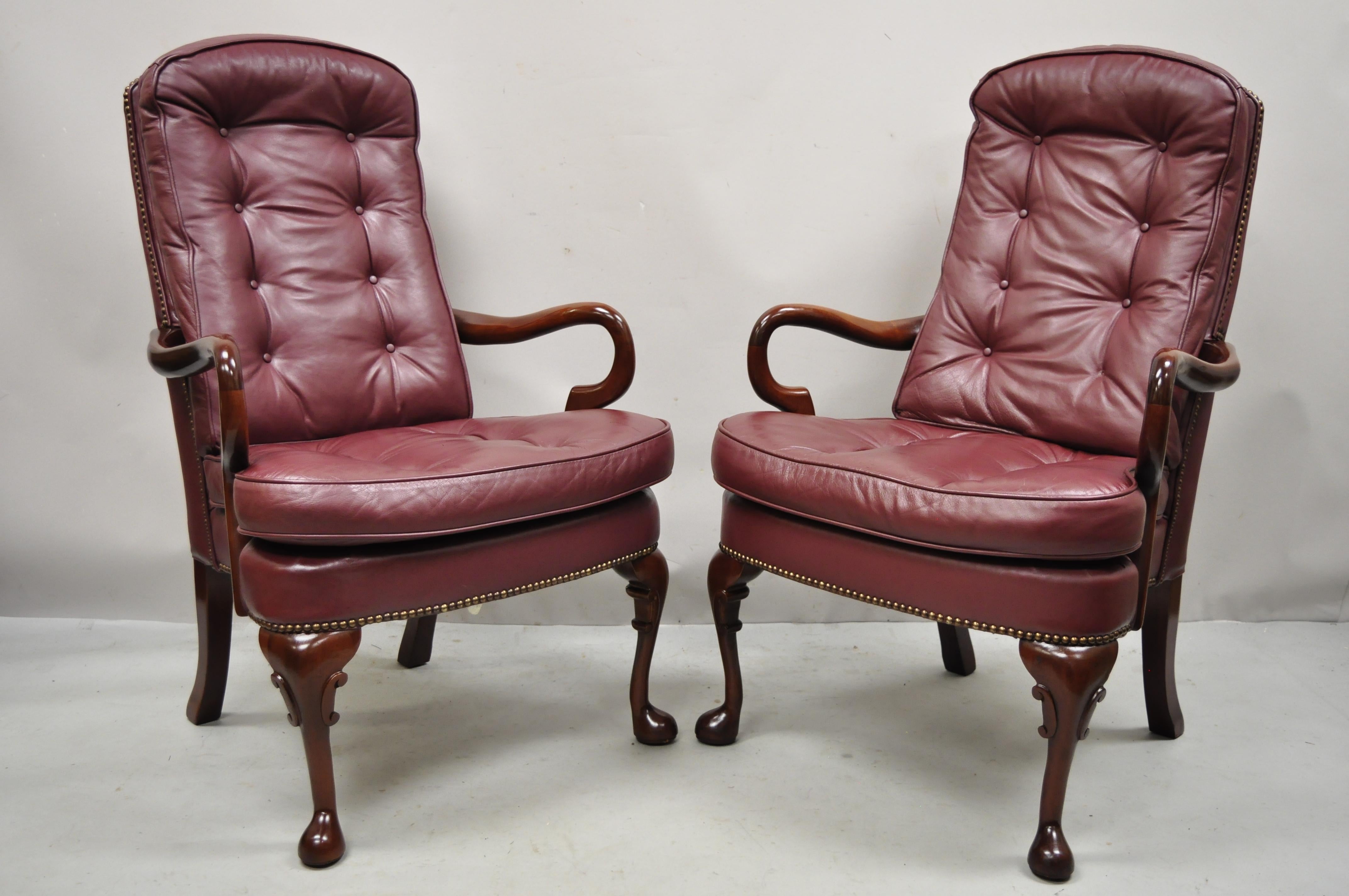 St. Timothy Chair Co. Burgundy leather Queen Anne Library Office arm chairs - a Pair. Item features burgundy leather button tufted upholstery, solid wood frame, beautiful wood grain, nicely carved details, original label, shapely Queen Anne legs,