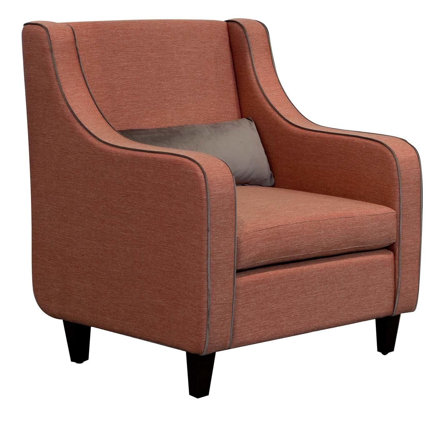 A testament to traditional craftsmanship and aesthetic balance, this elegant armchair's sweeping arms and welted seams give a polished look to the structured silhouette. Sitting on dark walnut-veneered solid wood feet, this comfortable armchair is