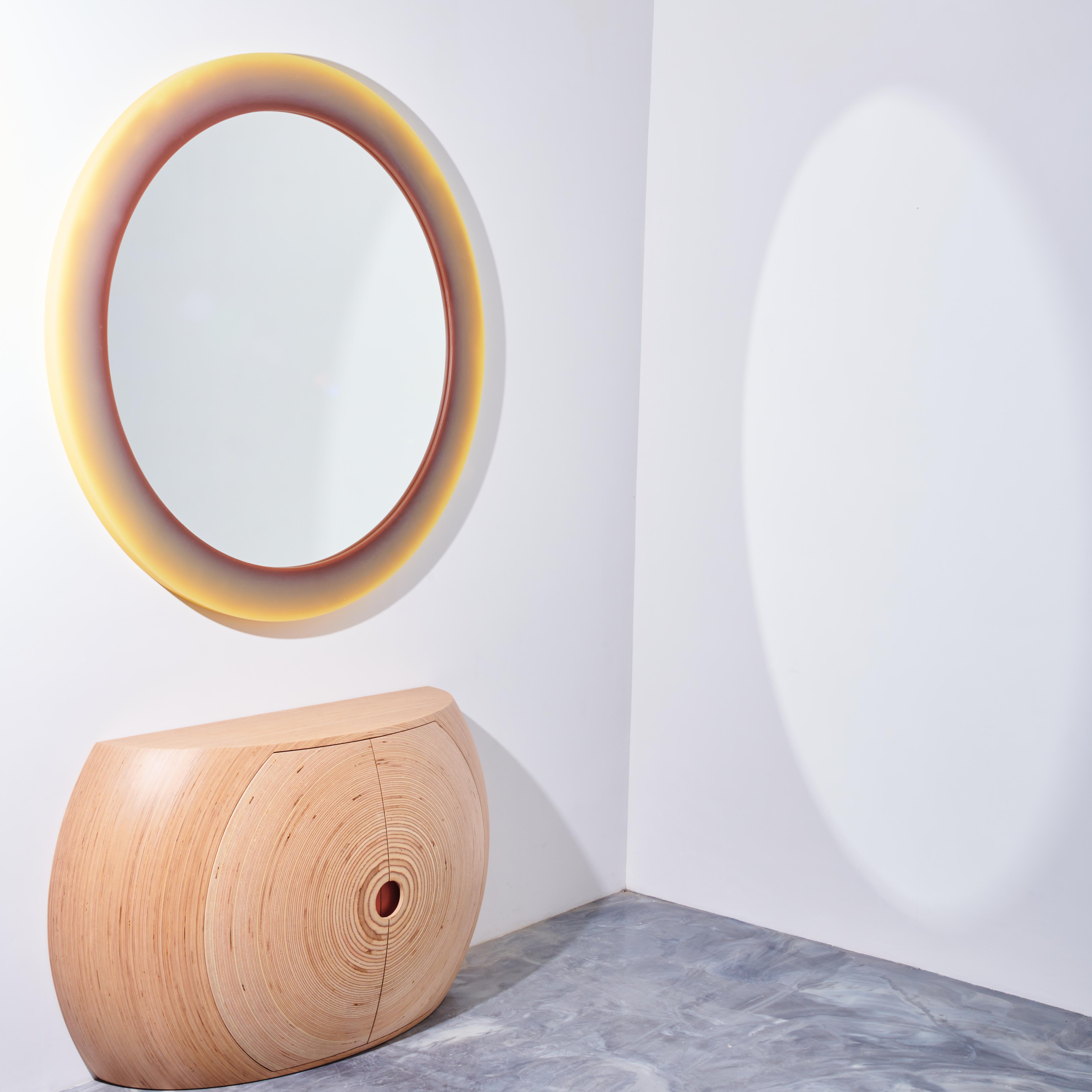 The Bubble Credenza. With a convex structure and concentric rings of stack-laminated Baltic birch plywood radiating from its center, the Bubble Credenza walks the line between expression and utility. 

This credenza and console is made from FSC