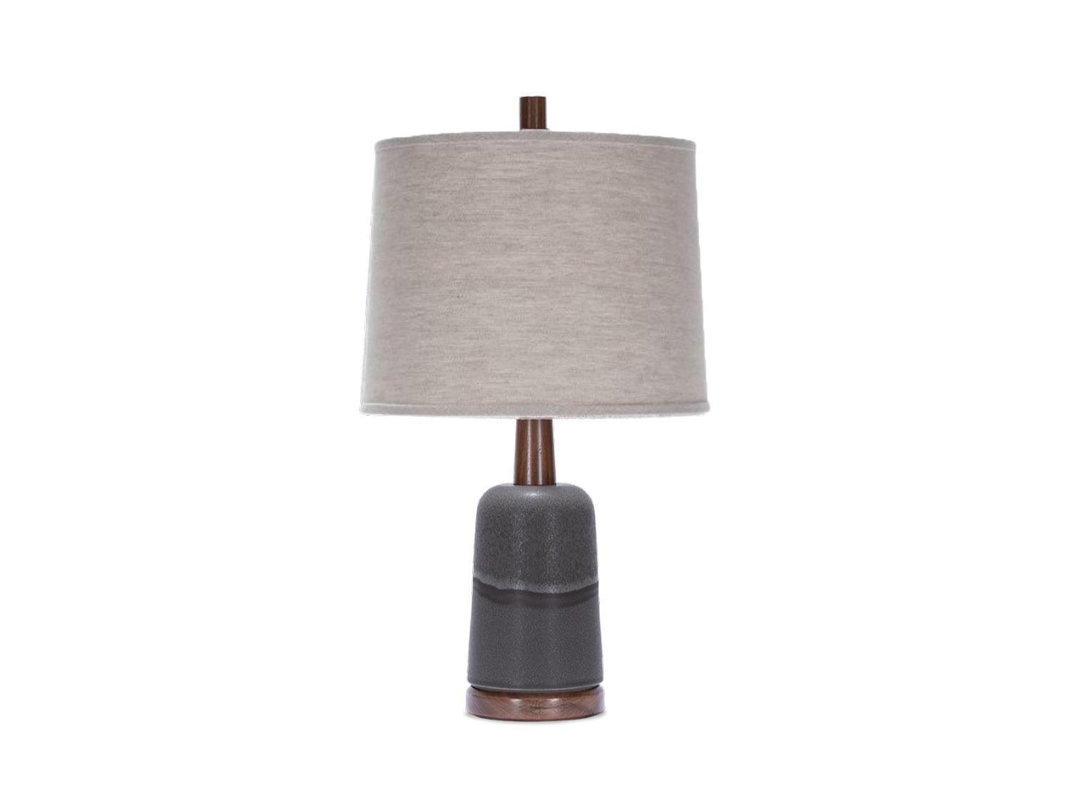 Handcrafted stoneware lamp made in upstate New York by Stone and Sawyer for Lawson-Fenning. Shown here in charcoal glaze, with walnut and satin brass details and a natural linen shade. 

Dimensions: 
Overall Height: 22 height
Shade: 12 diameter