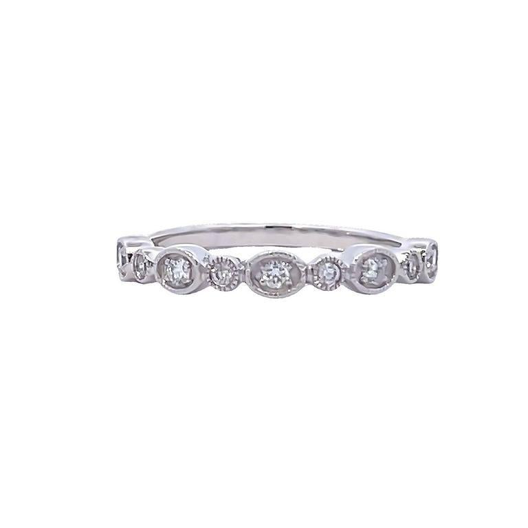 This simple and elegant diamond band ring is a perfect symbol of your commitment to love, this particular design makes you look very stylish. The 14k white gold band is set with multiple round white diamonds with a total weight of 0.16 carats, every