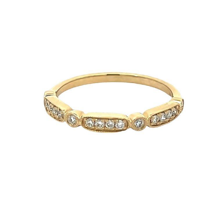 This simple and elegant diamond band ring is a perfect symbol of your commitment to love, this particular design makes you look very stylish. The 14k yellow gold band is set with multiple round white diamonds with a total weight of 0.18 carats,
