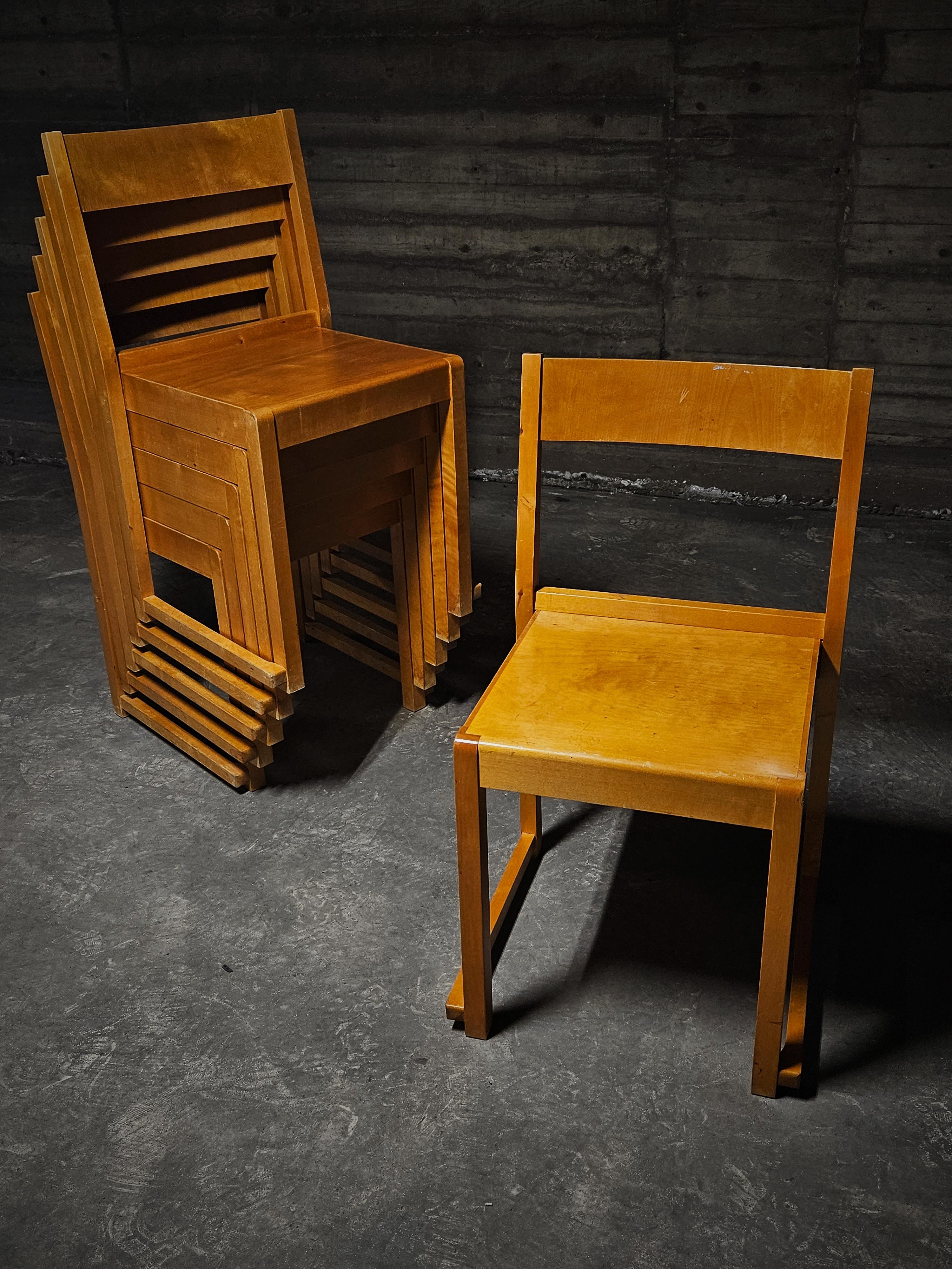 Functionalistic stackable dining chairs model 'Orchestra' designed by Sven Markelius, Sweden, 1930s. 

These chairs feature a minimalist modern design, the chair backs are composed of hardwood birch while the seat is made up of bent plywood.