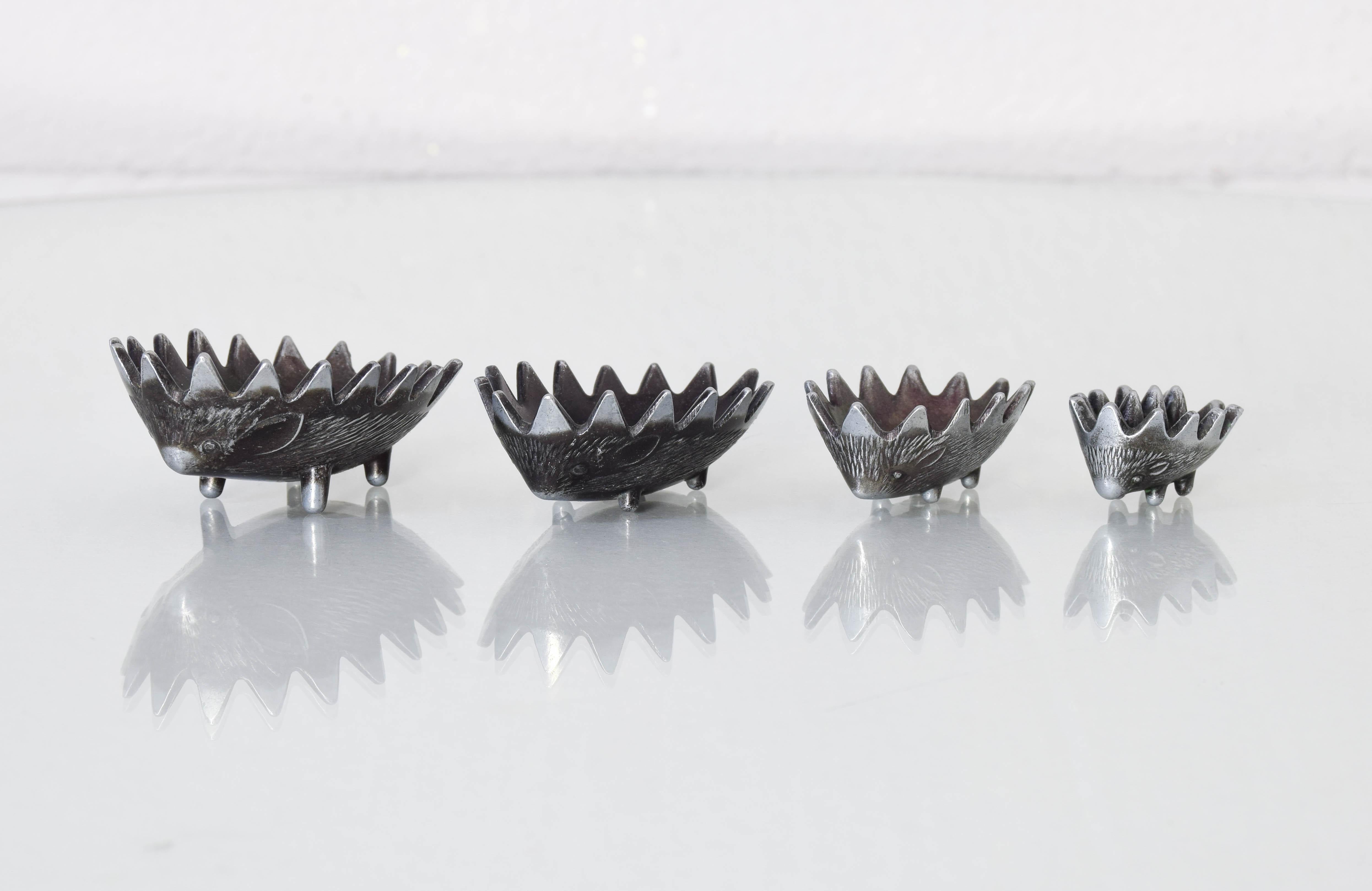 After an original design in brass by Walter Bosse, this pewter ashtray was used by the Russian airline Aeroflot as a souvenir gift in the late 1950s. 
Concave urchin containers nest inside each other from largest to smallest, forming a Full hedgehog