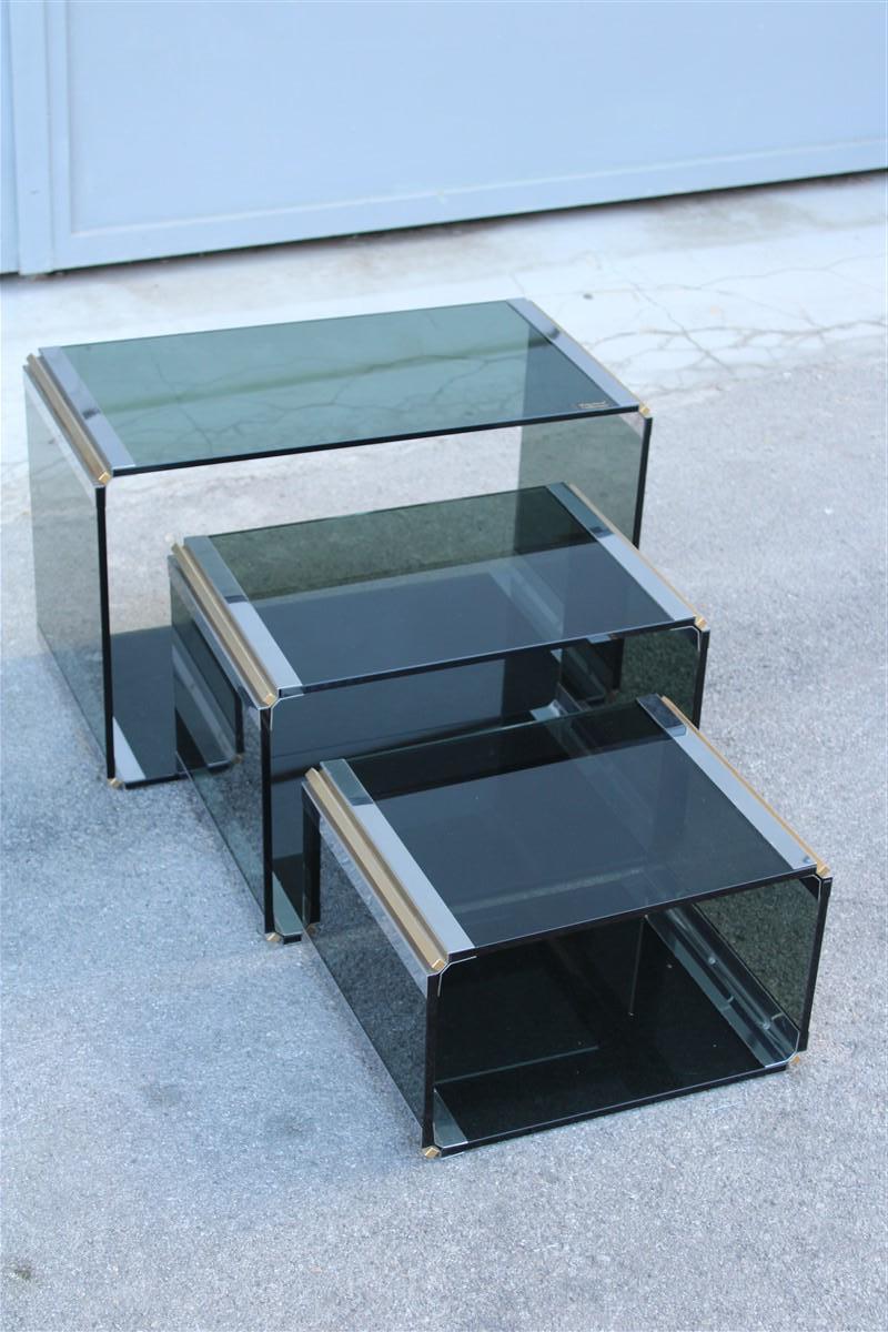 Stackable tables Romeo Rega 1970, steel and brass crystal, Measures: large height cm.40, width cm.65, depth cmn.32, height height cm.31, width cm.48, depth cm.32, small height cm.24, width 40 cm, depth cm.32.