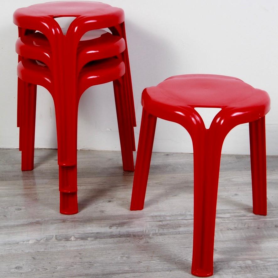 Set of 4 stackable tripod stools made by Henry Massonnet for Stamp in the 70s. Stamped in the mass. Fire engine red colored plastic. Stable seat. All are in good condition. 4 sets are available.