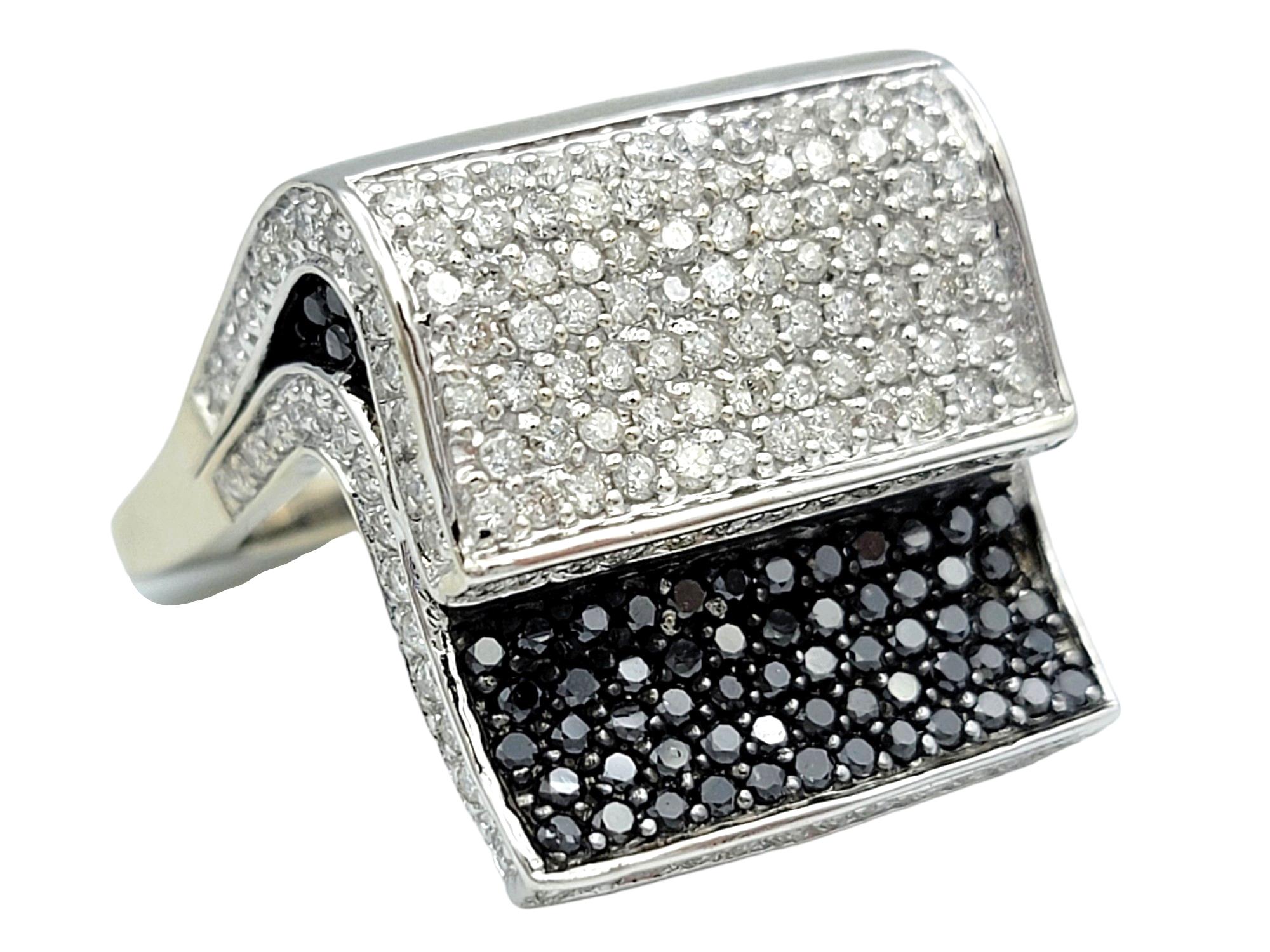 Ring size: 9

Make a bold statement with this contemporary stacked pavé diamond squared cocktail ring, crafted in polished 14 karat white gold. This striking piece features an innovative design that combines the classic elegance of white diamonds