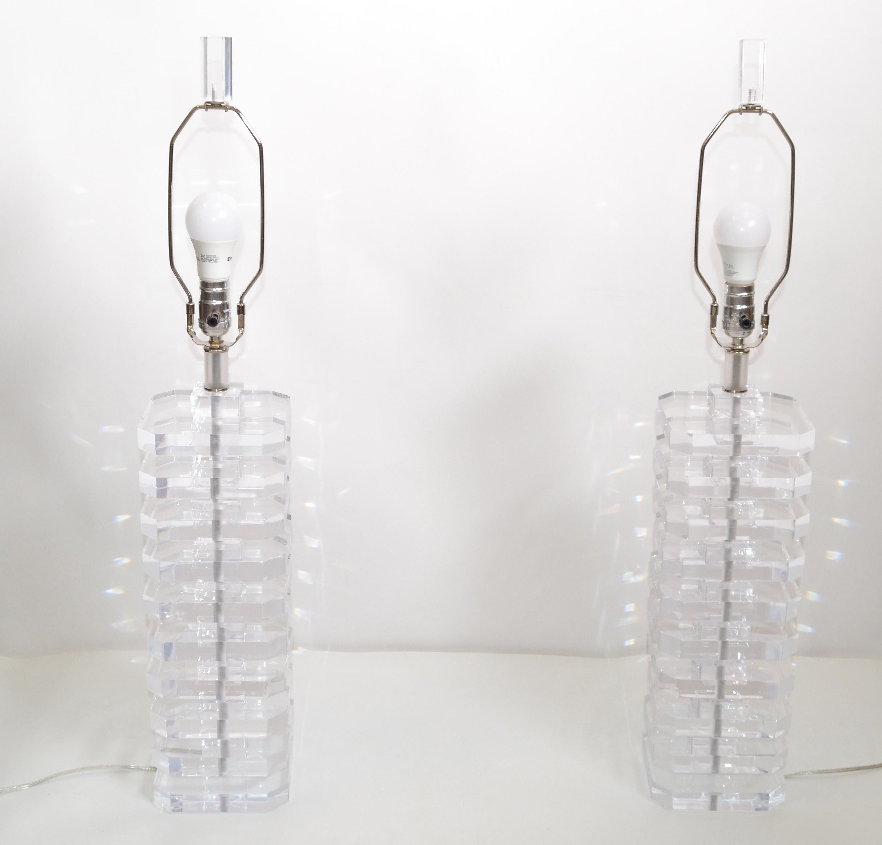 Pair of transparent stacked Mid-Century Modern Lucite table lamps.
Nickel hardware.
Wired for the U.S. and each takes a regular / LED bulb.
Sold with matching shades.